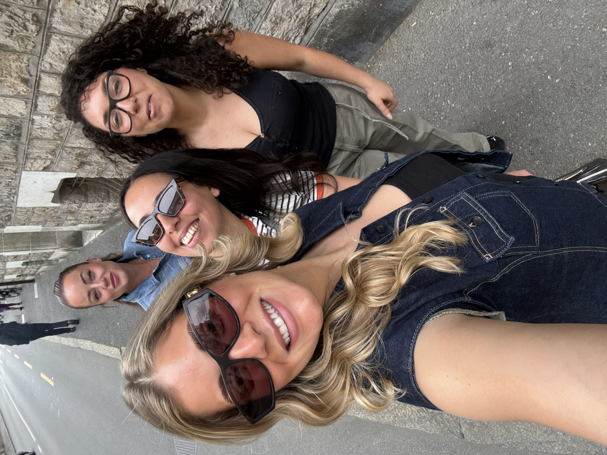 Women pose for group selfie on Geneva street