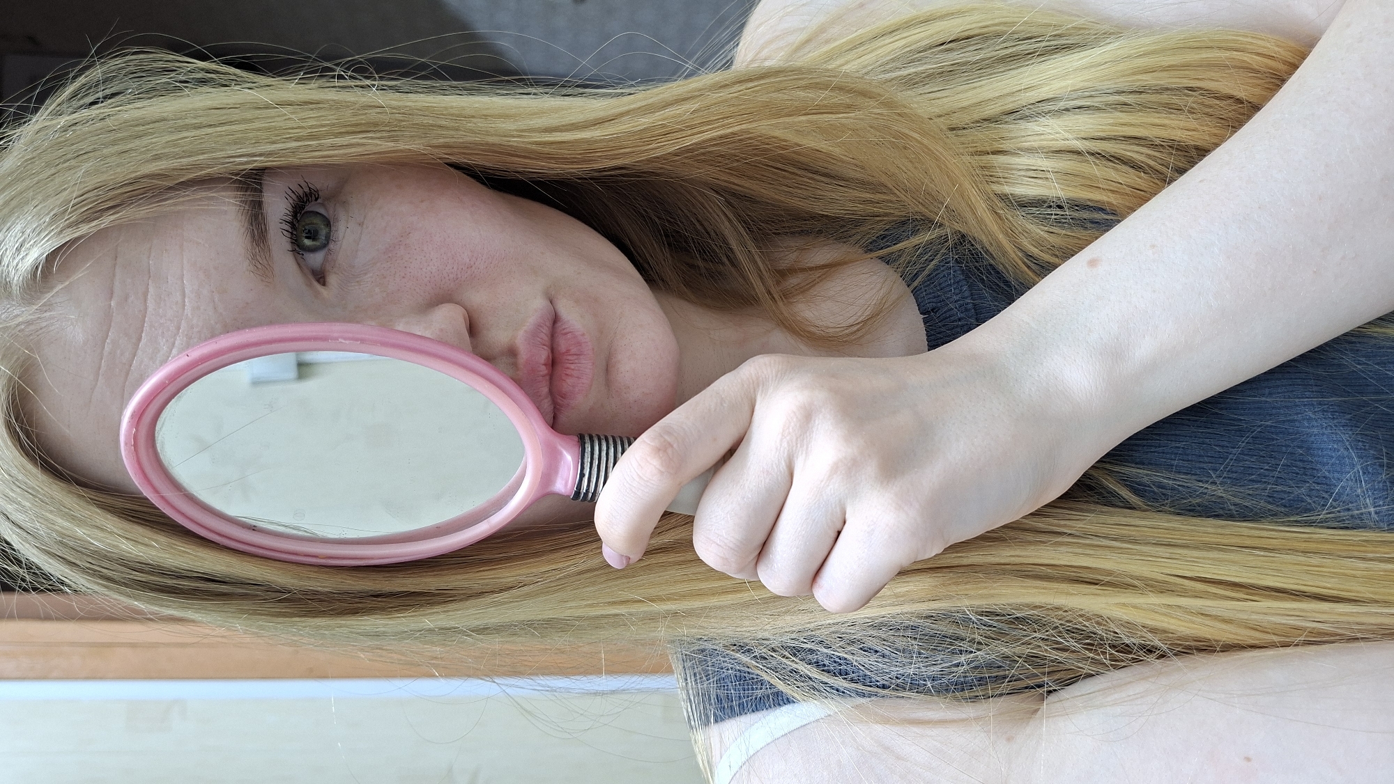 Woman poses with pink mirror in Russian home