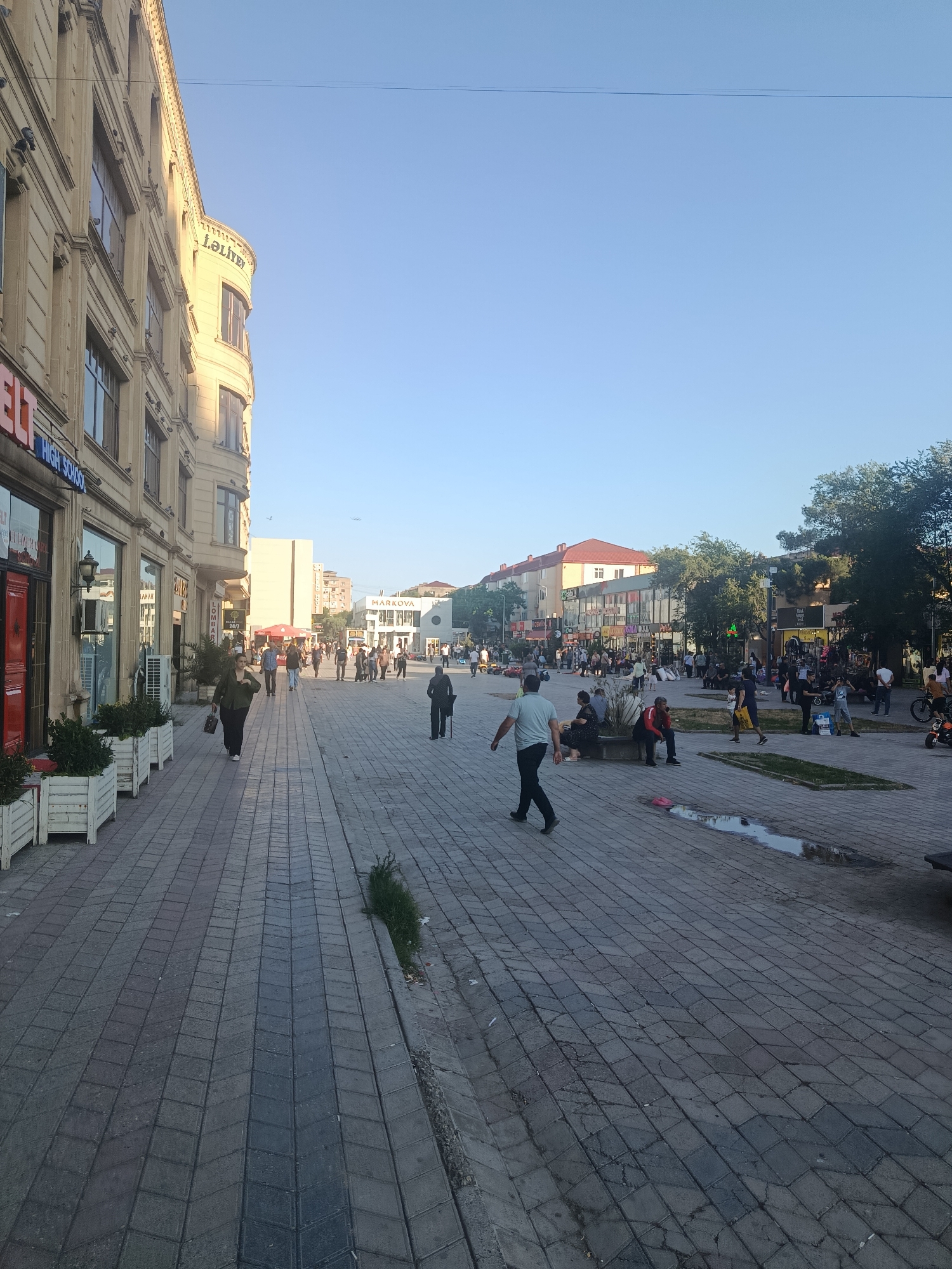 Pedestrian street scene in sunny Sumgayit, Azerbaijan