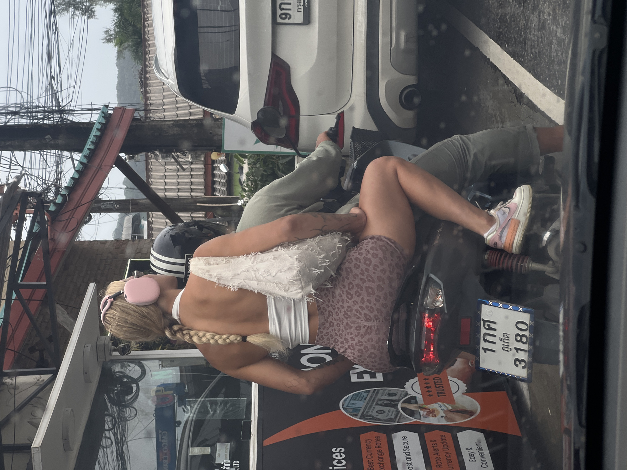 Street scene photographed from vehicle in Southeast Asian city