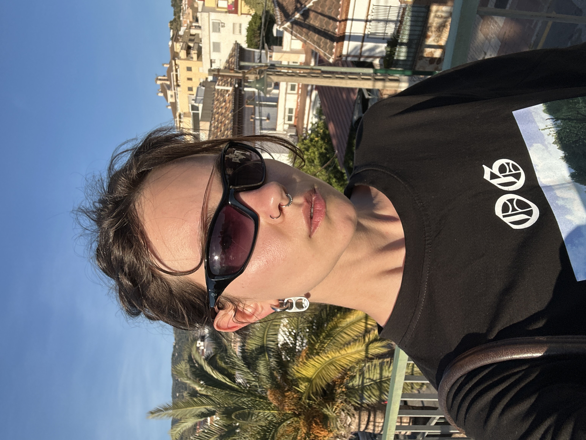 Visitor documents sunny afternoon tour of Málaga from elevated viewpoints