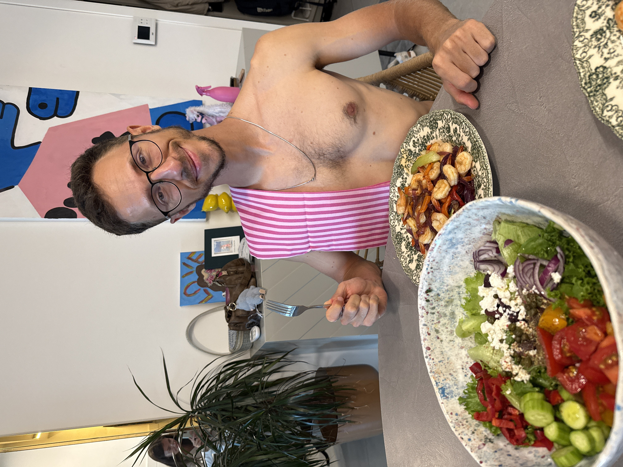 Man enjoys multi-course salad meal at gray table