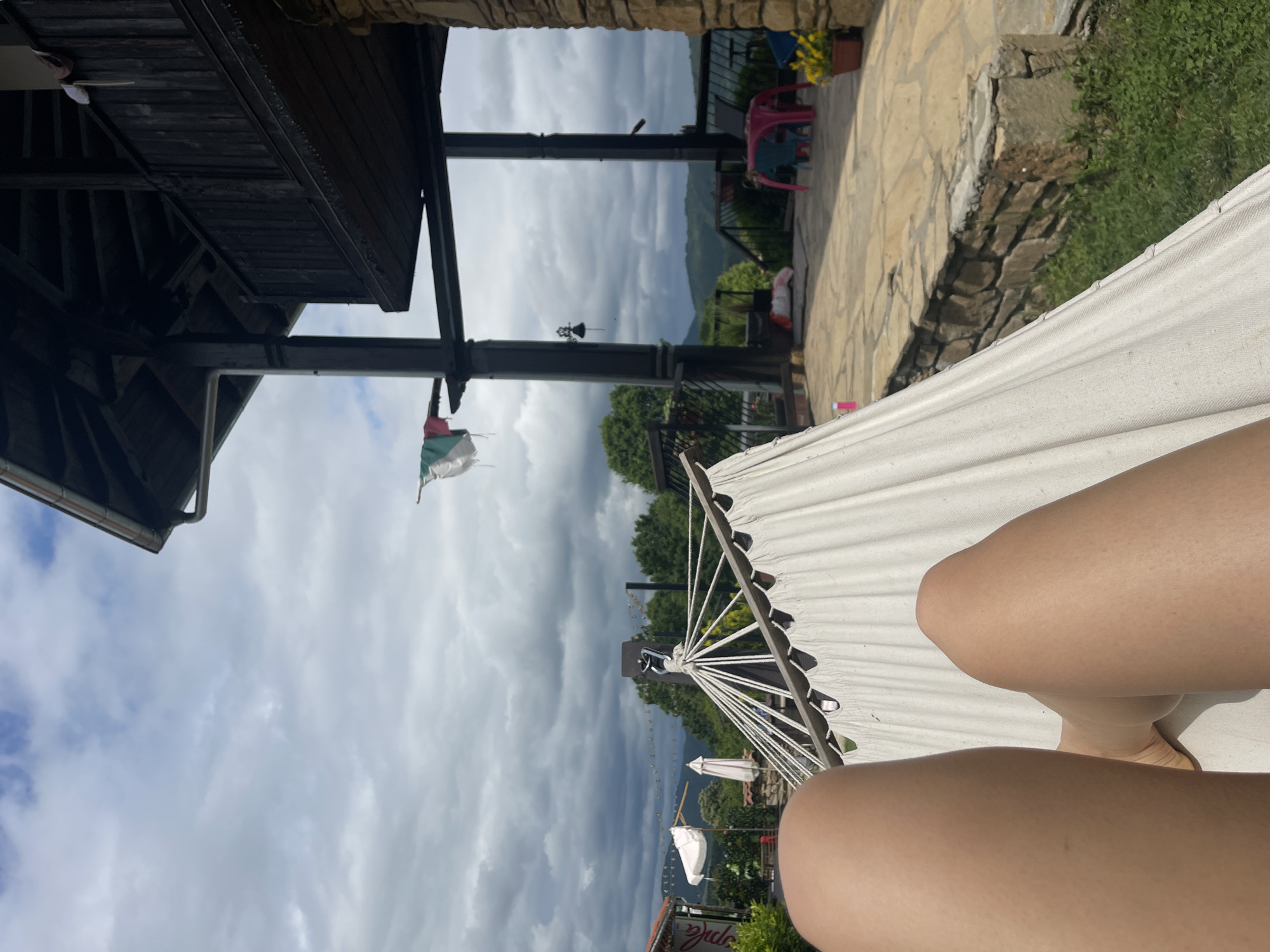 Person relaxes in hammock in Bulgarian village morning