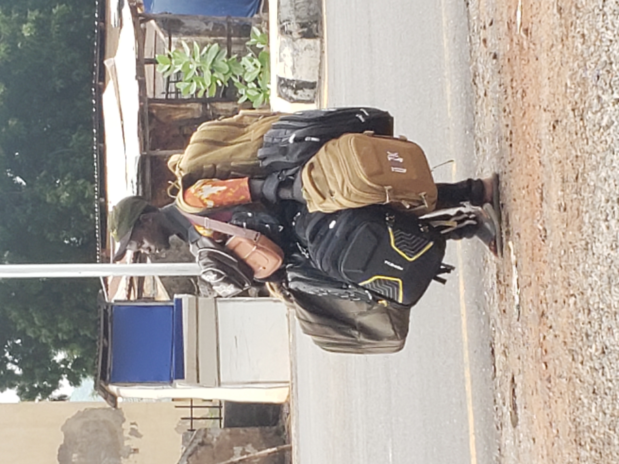Daily life unfolds on Adankolo road amid cloudy afternoon