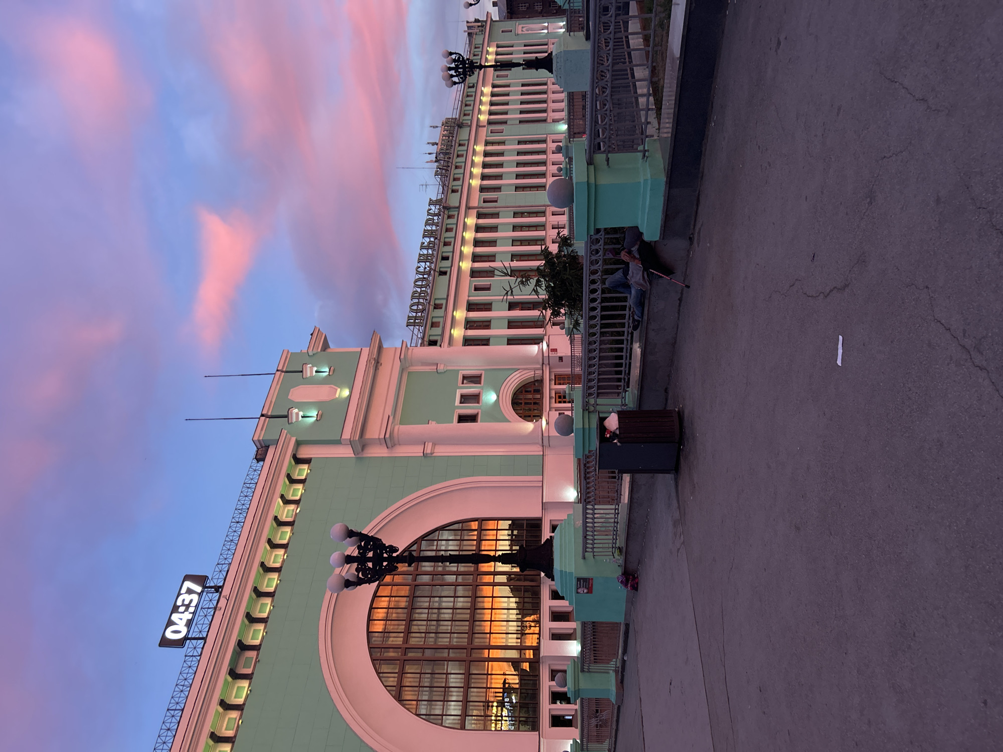 Vivid dusk sky over an urban street, clock tower visible
