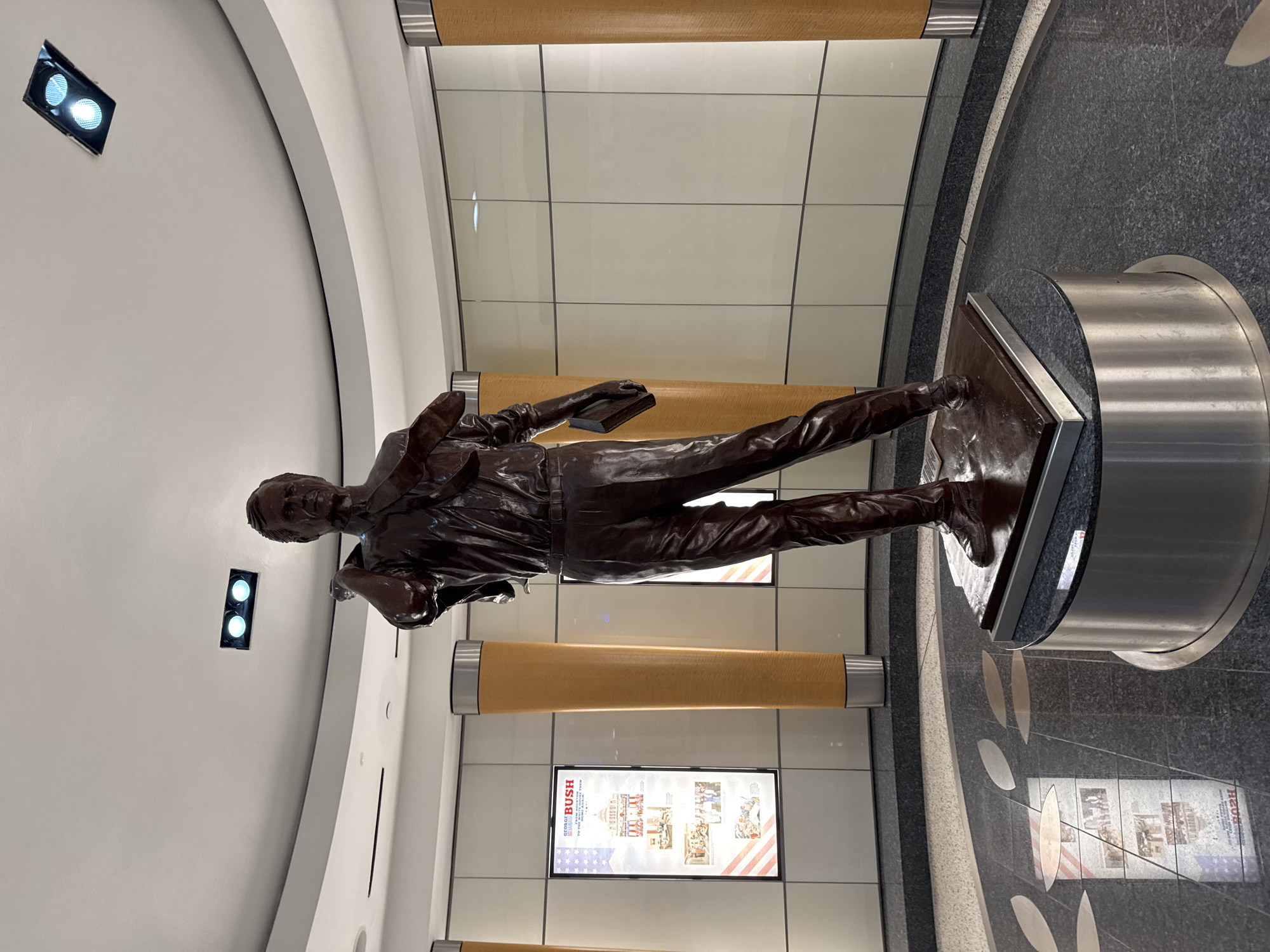 Bronze statue of suited man with book observed in Houston interior