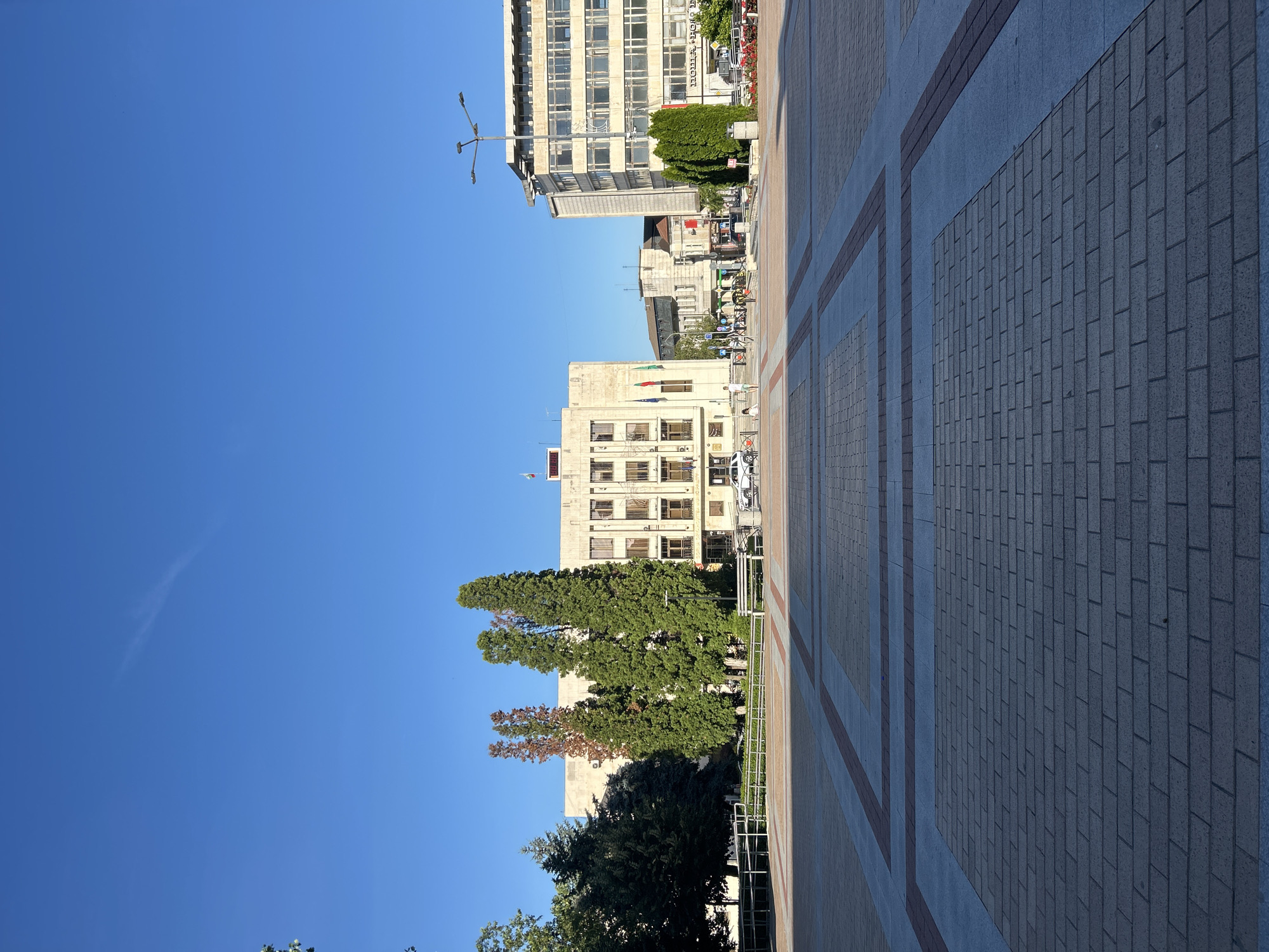 Afternoon in a sunny city square with cafés and cold drinks