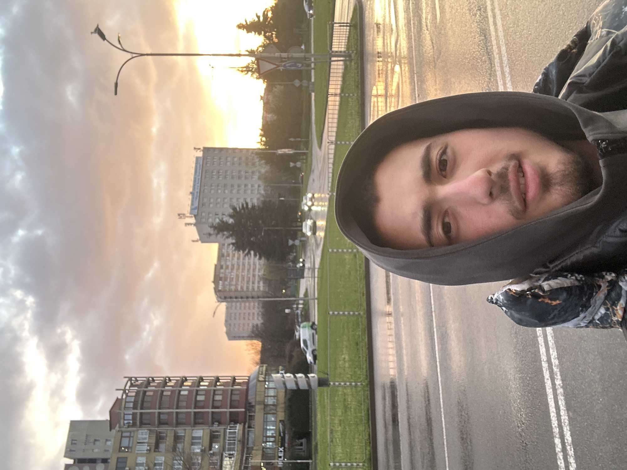 Man takes selfie on wet street during sunset in Burgas