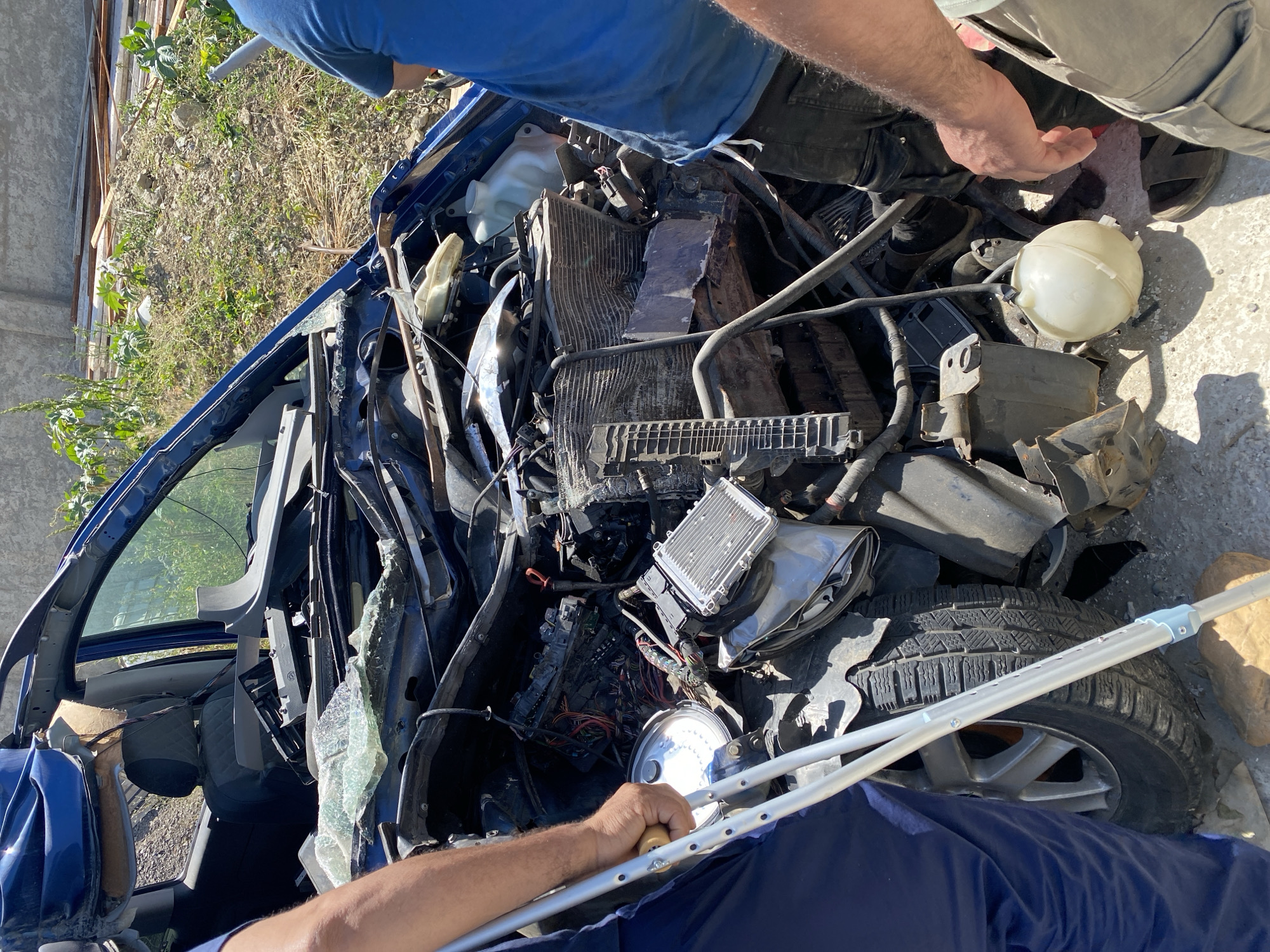 Severely damaged blue van documented at Baraki salvage yard