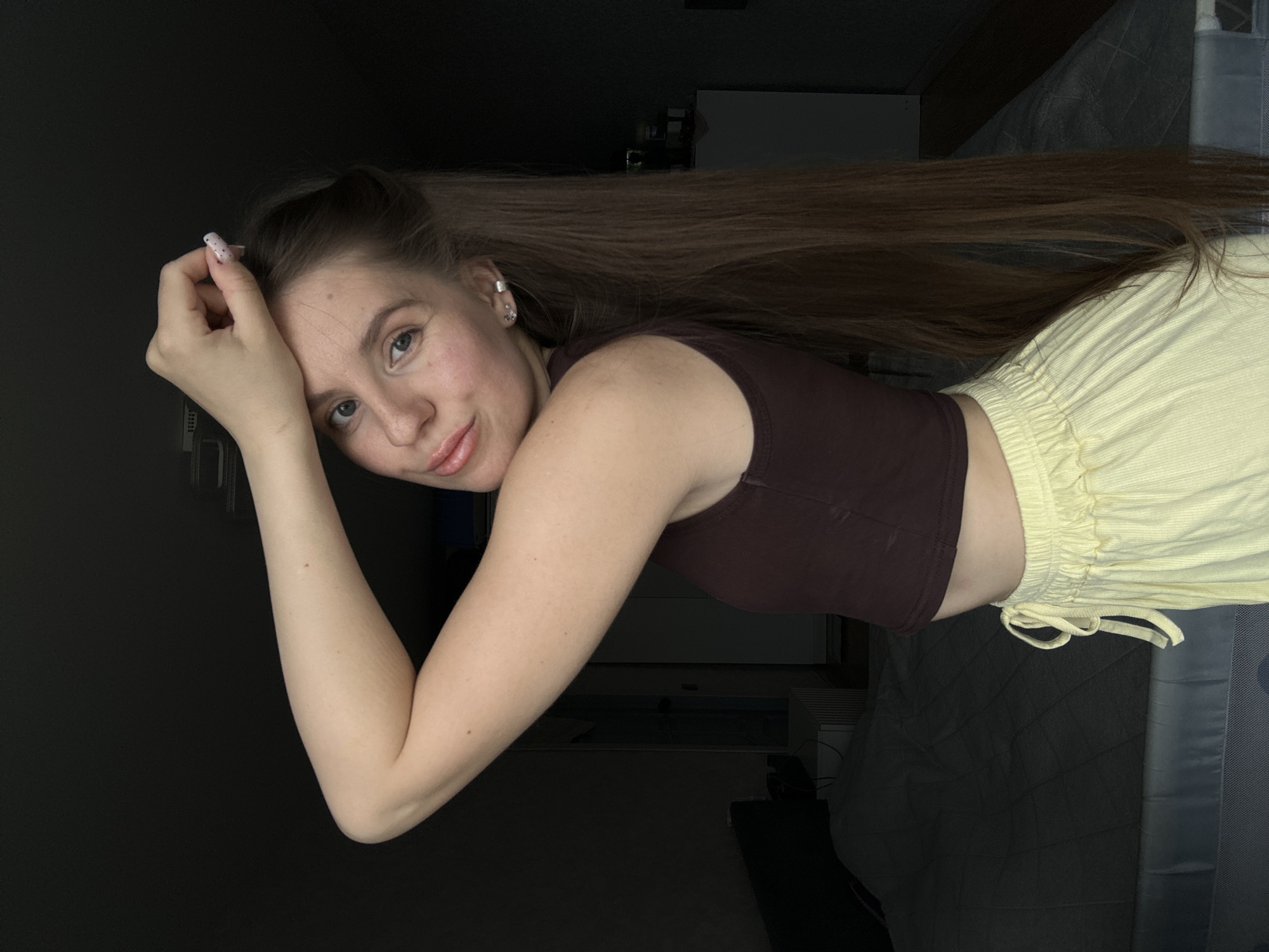 Woman takes selfies in indoor setting in Klin, Russia