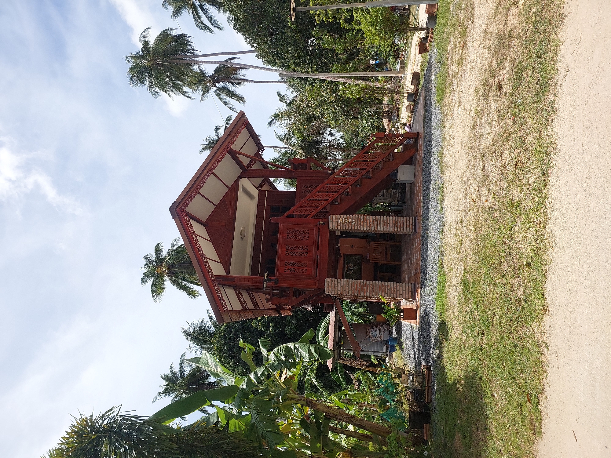Traditional stilt houses and coconut piles in rural Koh Samui