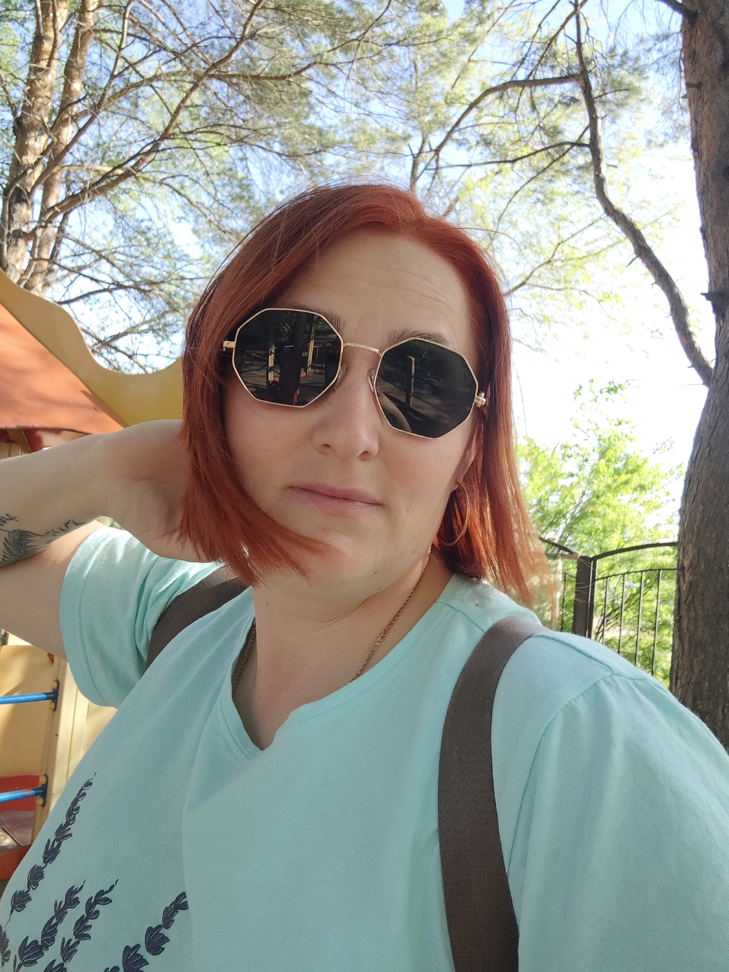 Woman takes selfie near playground in Chaikovsky, Russia