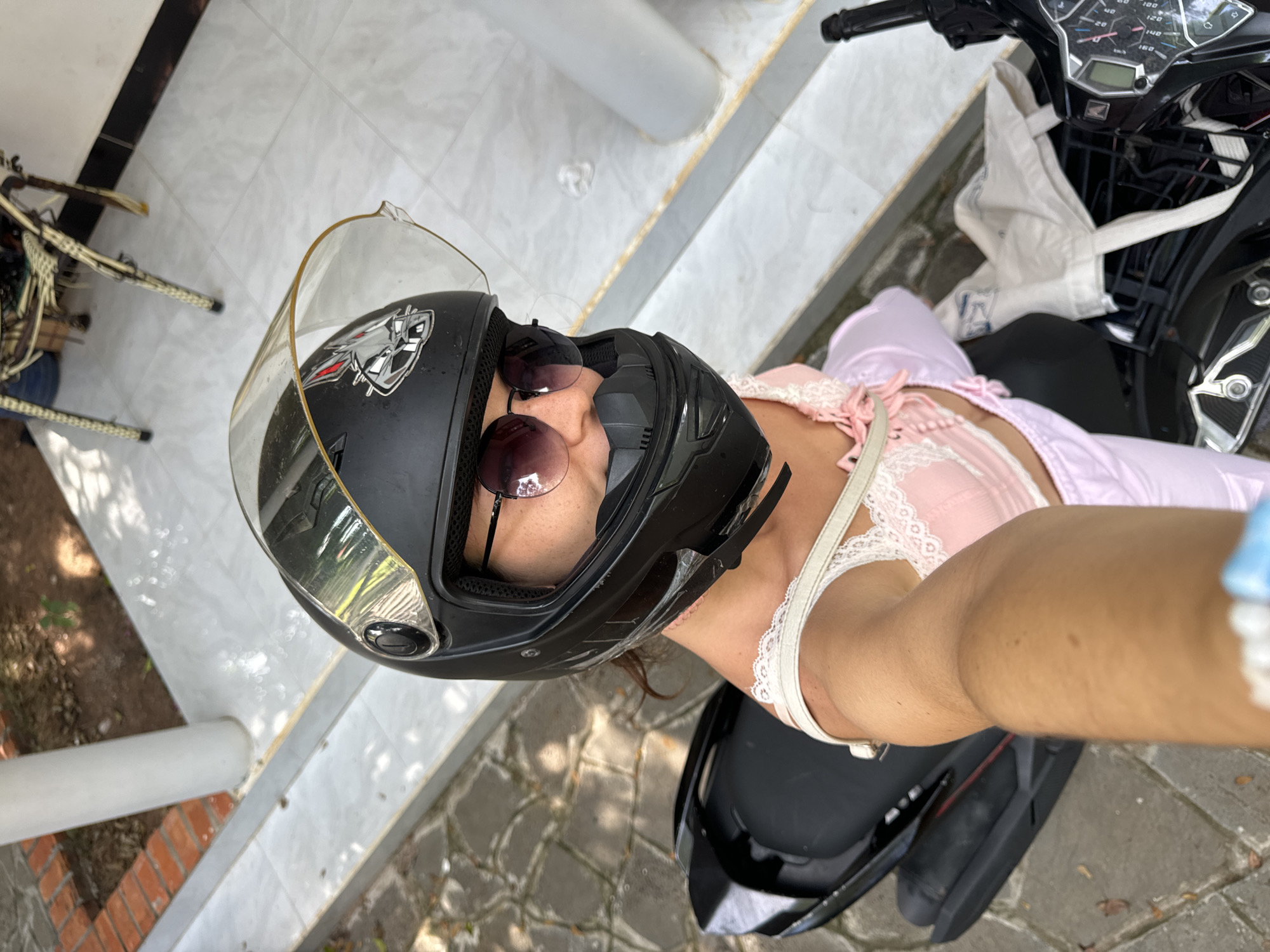 Scooter selfie session in Mũi Né, pink outfit and wolf helmet