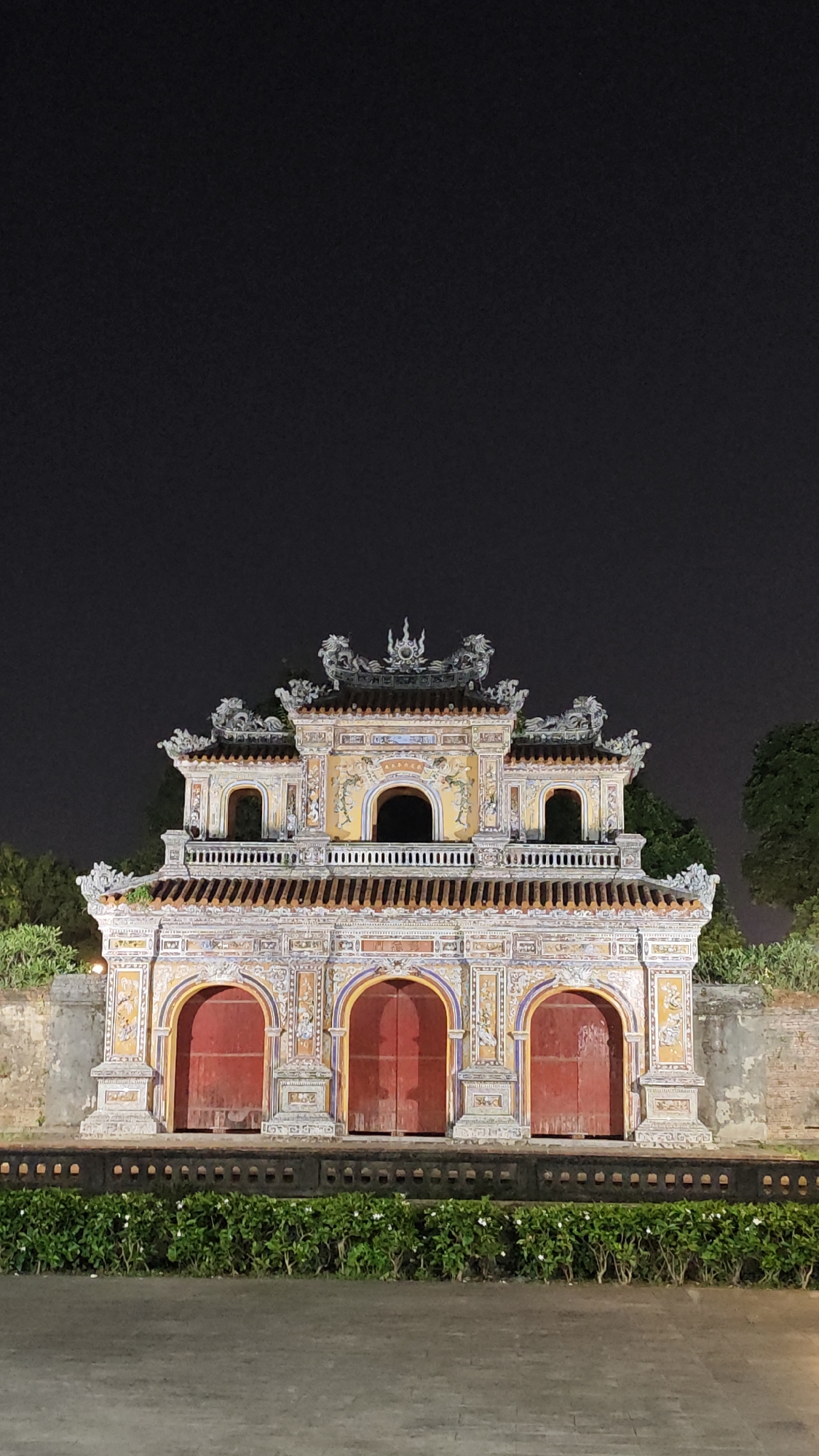 Ornate three-arched gate observed at night in Vietnam