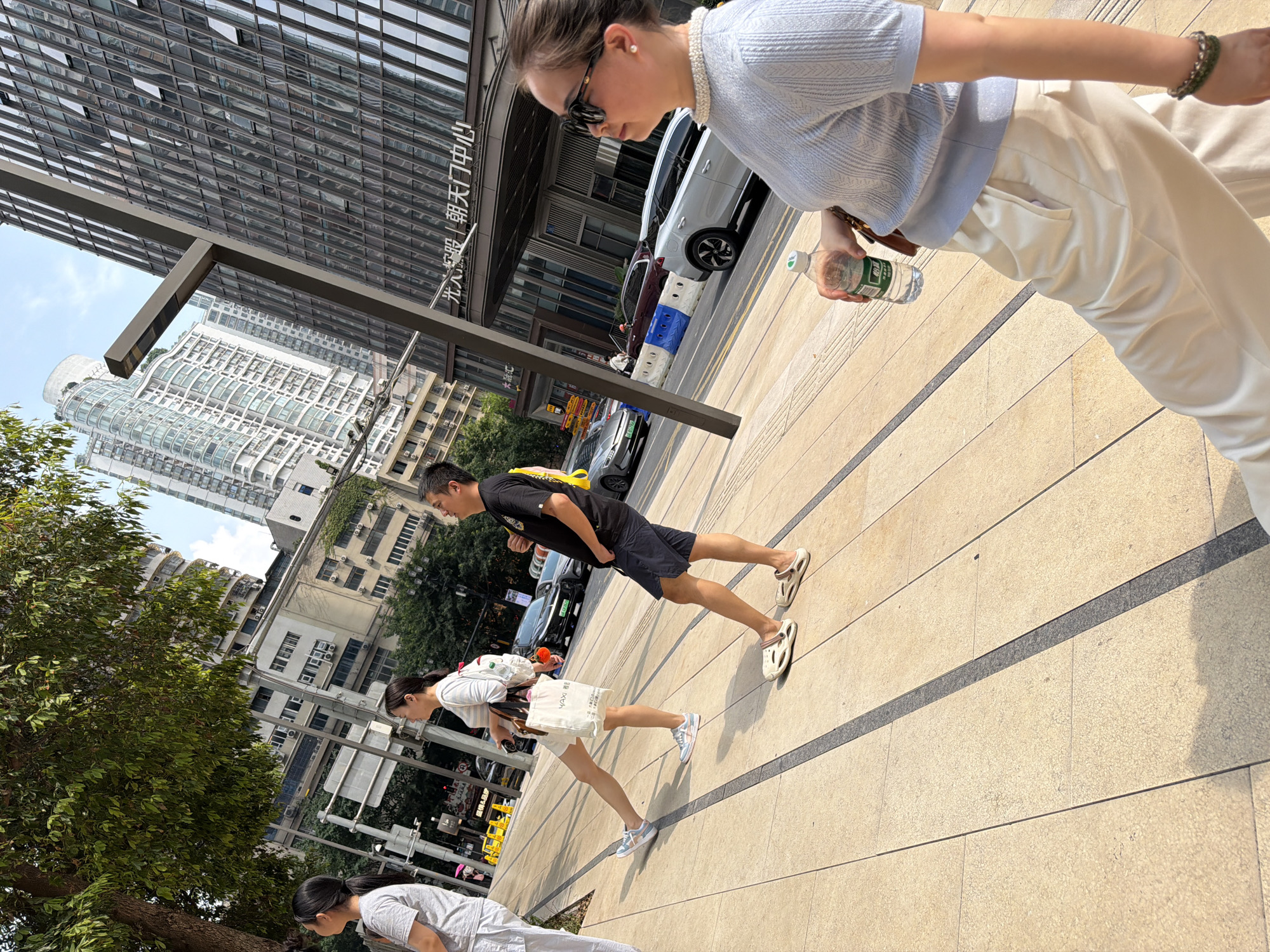 Crowds mill around Raffles City Chongqing on a sunny morning