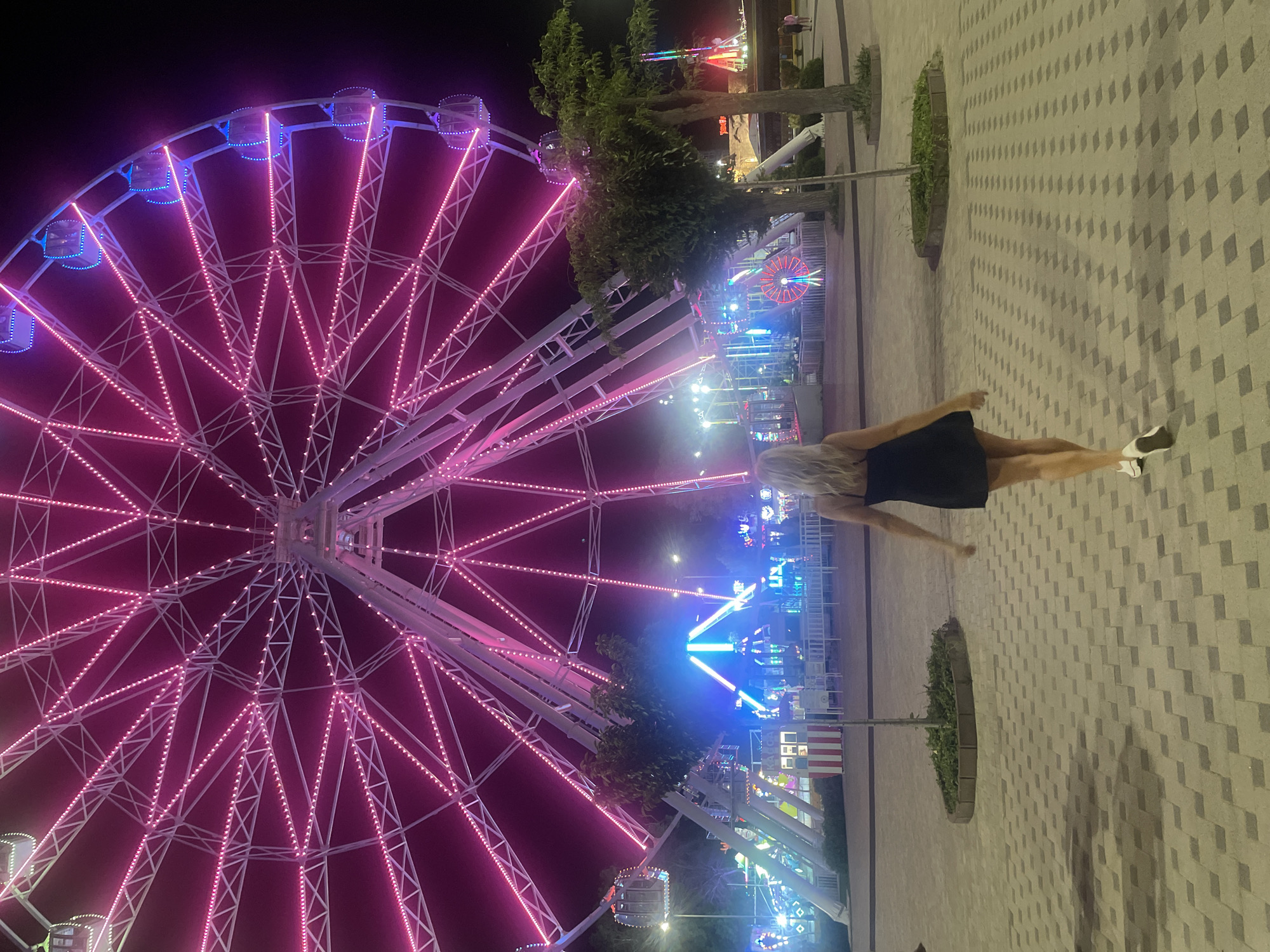 Anapa amusement park at night, Ferris wheel and toy cars