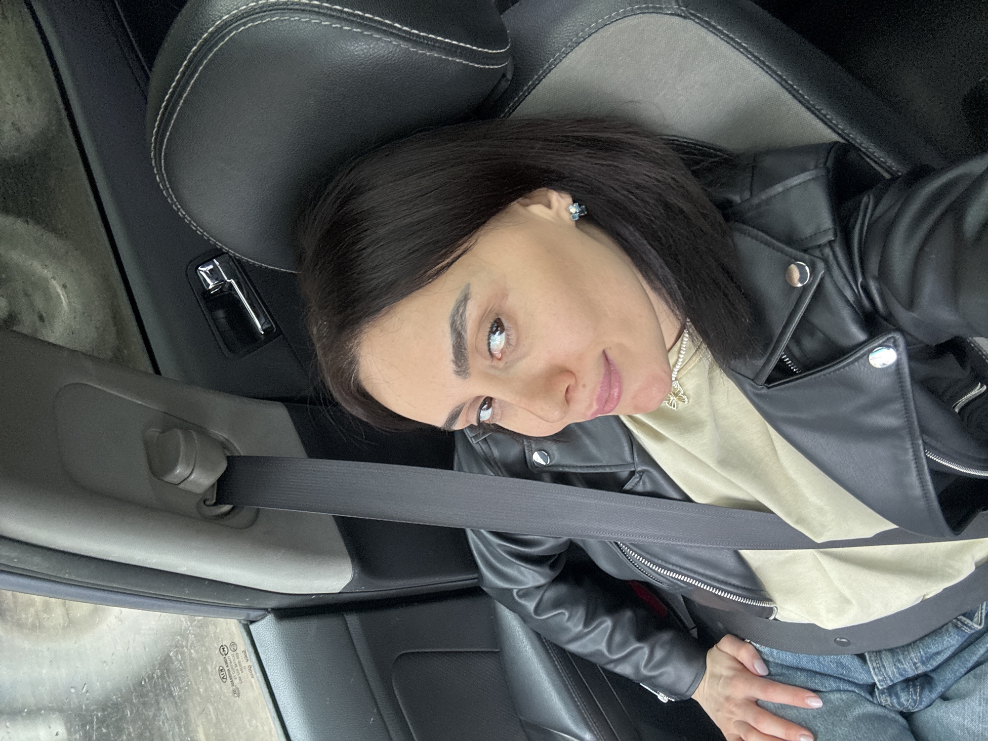 Woman takes car selfies in Tbilisi vehicle