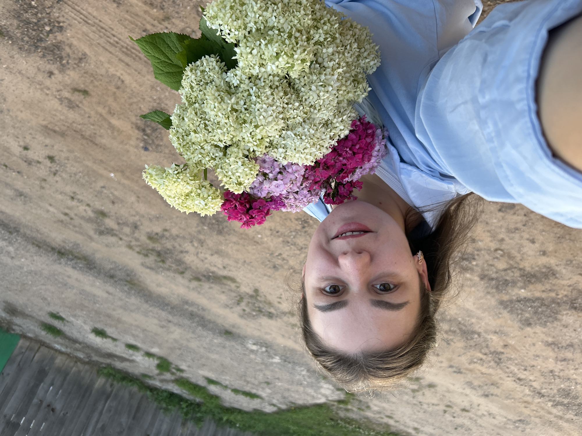 Bouquets and a dirt road on a summer afternoon in rural Russia