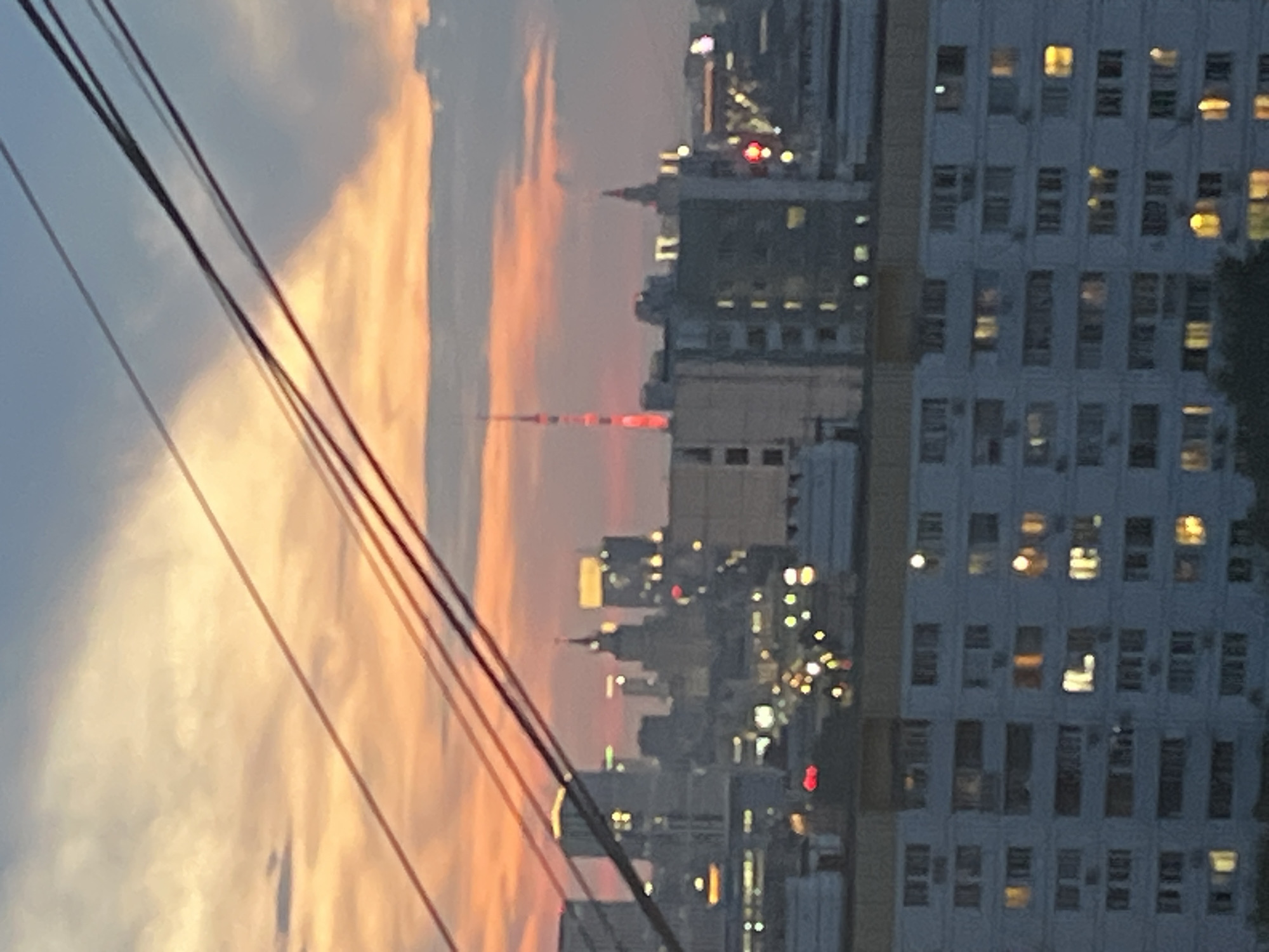 City skyline observed under dramatic sunset conditions