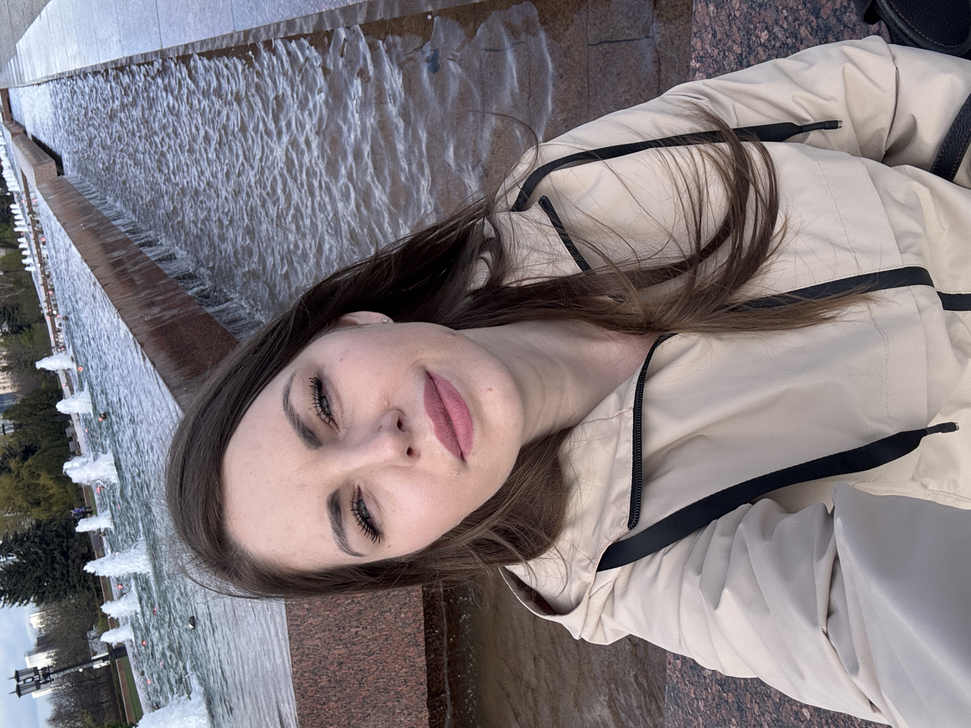 Woman photographed at Moscow Victory Park fountain amid cloudy skies