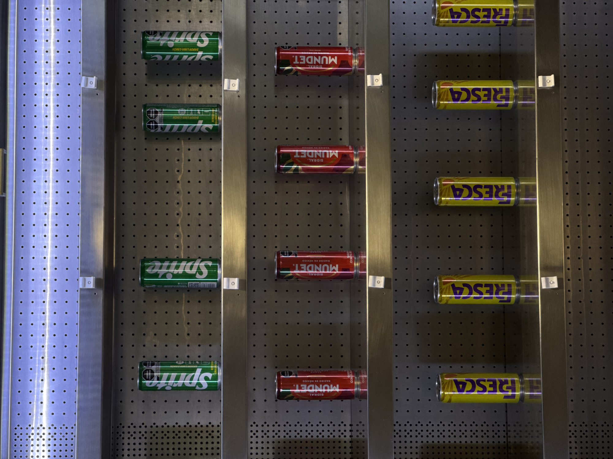 Soda vending machine stocked with beverages observed in Puebla