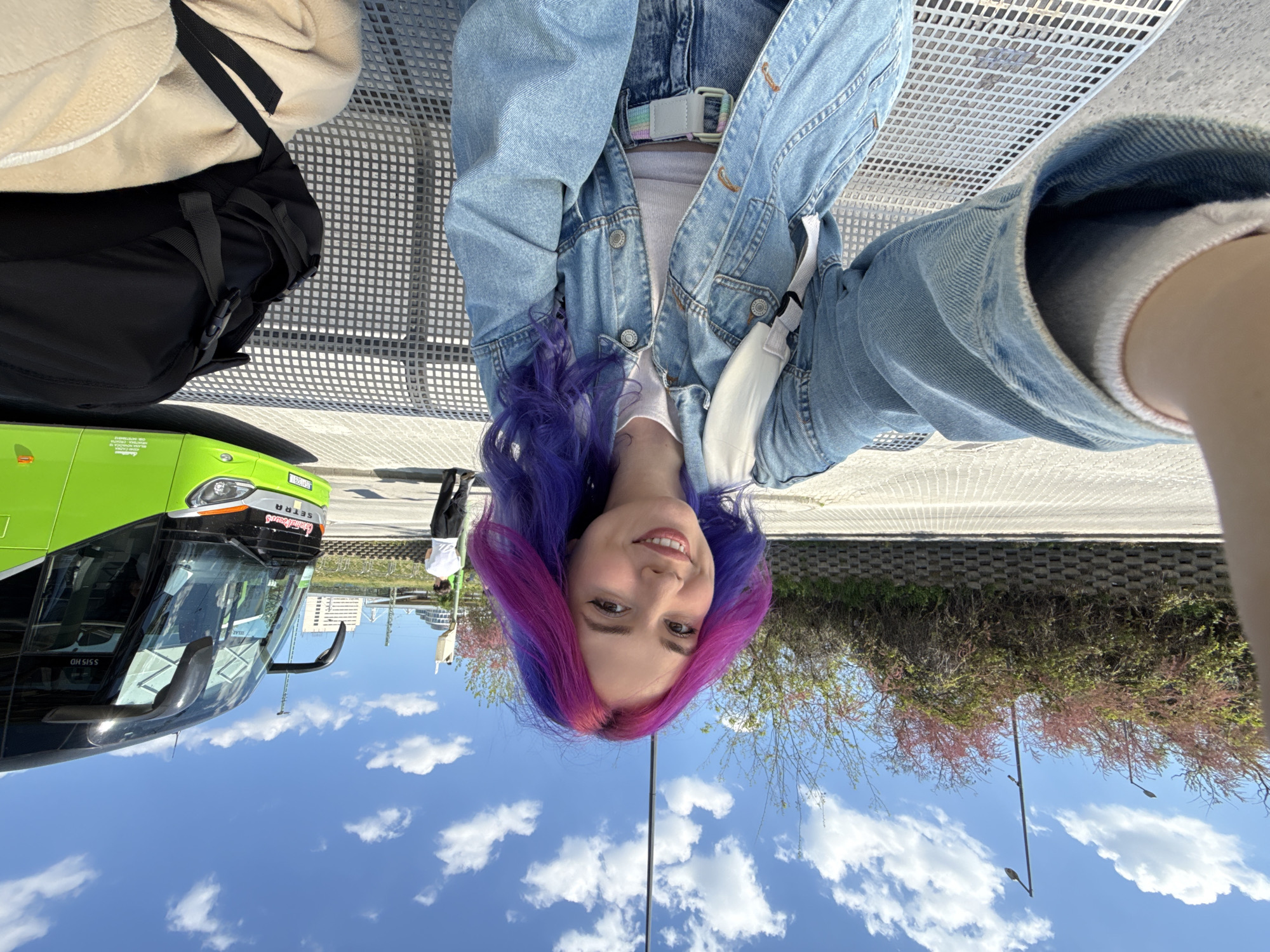 Woman takes colorful hair selfies at Budapest tram station