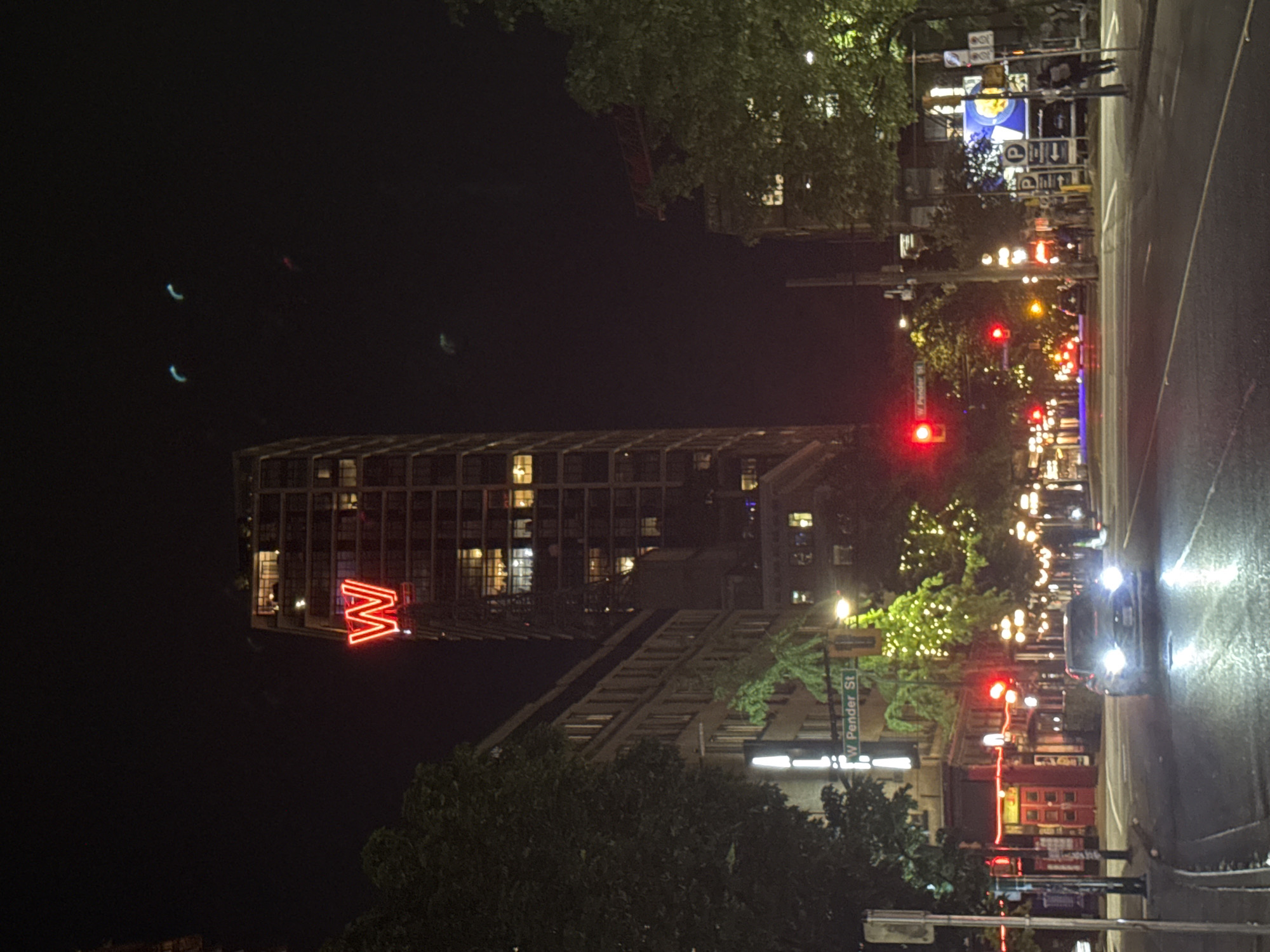 Vancouver building with illuminated W sign observed at night