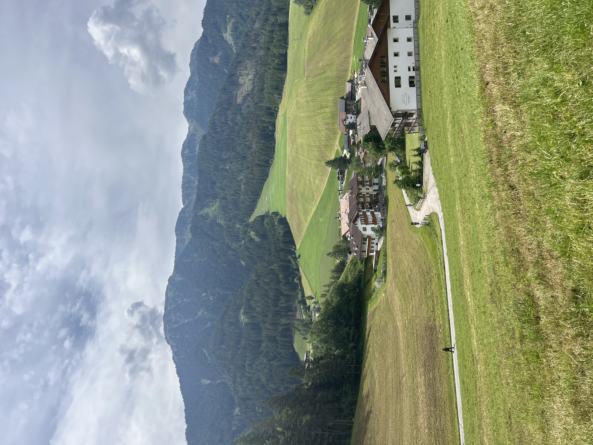 Morning walk through an Alpine village nestled below mountain peaks