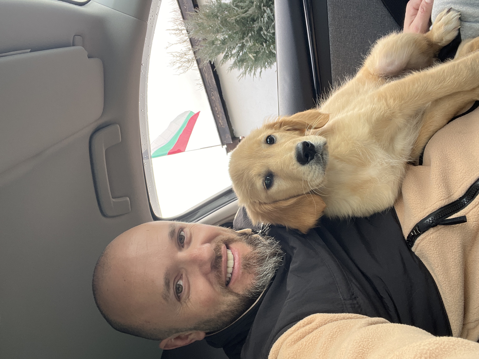 Man takes selfie with puppy near garage in Bulgaria