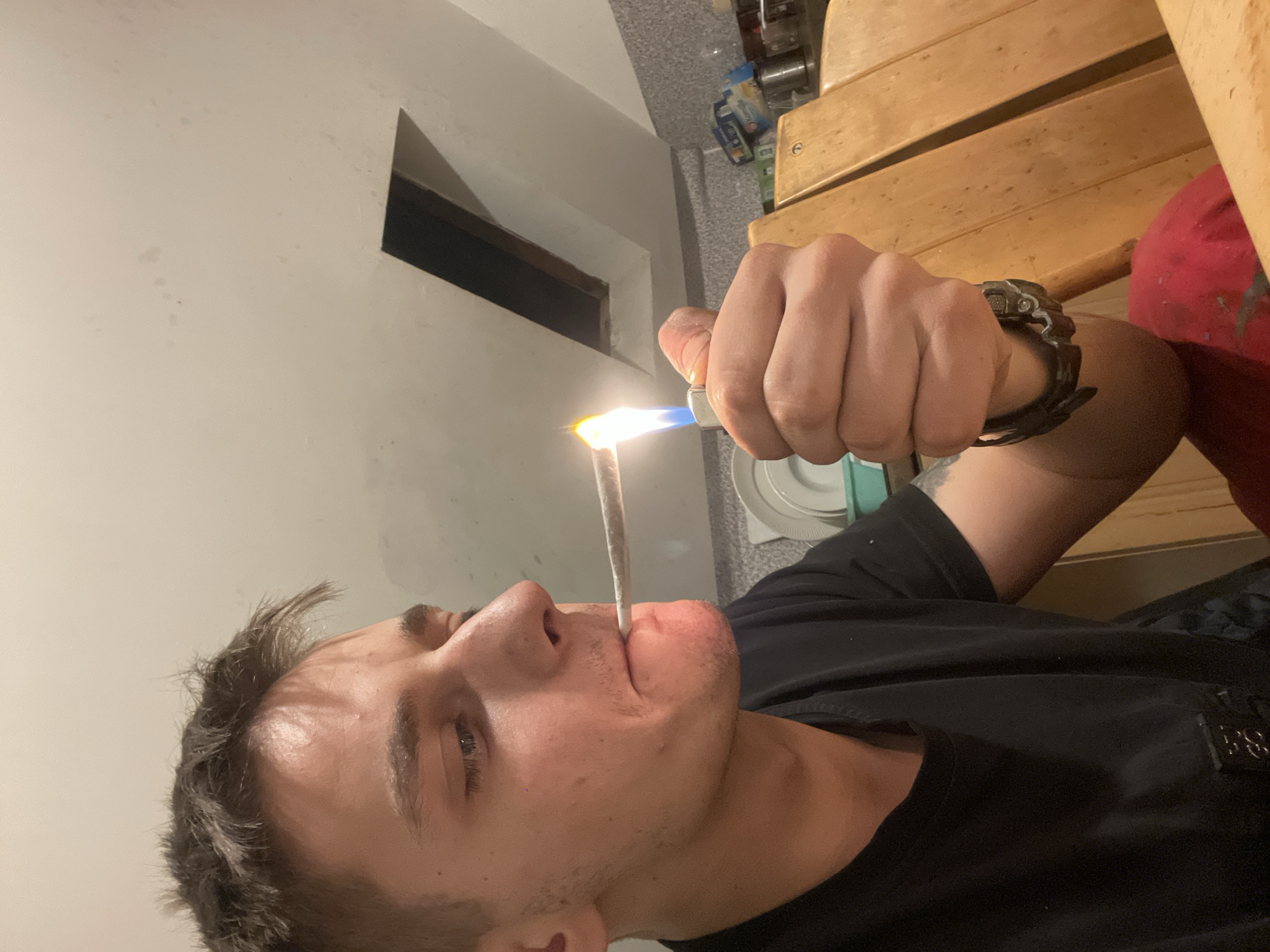 Young man cooks and takes selfies in kitchen