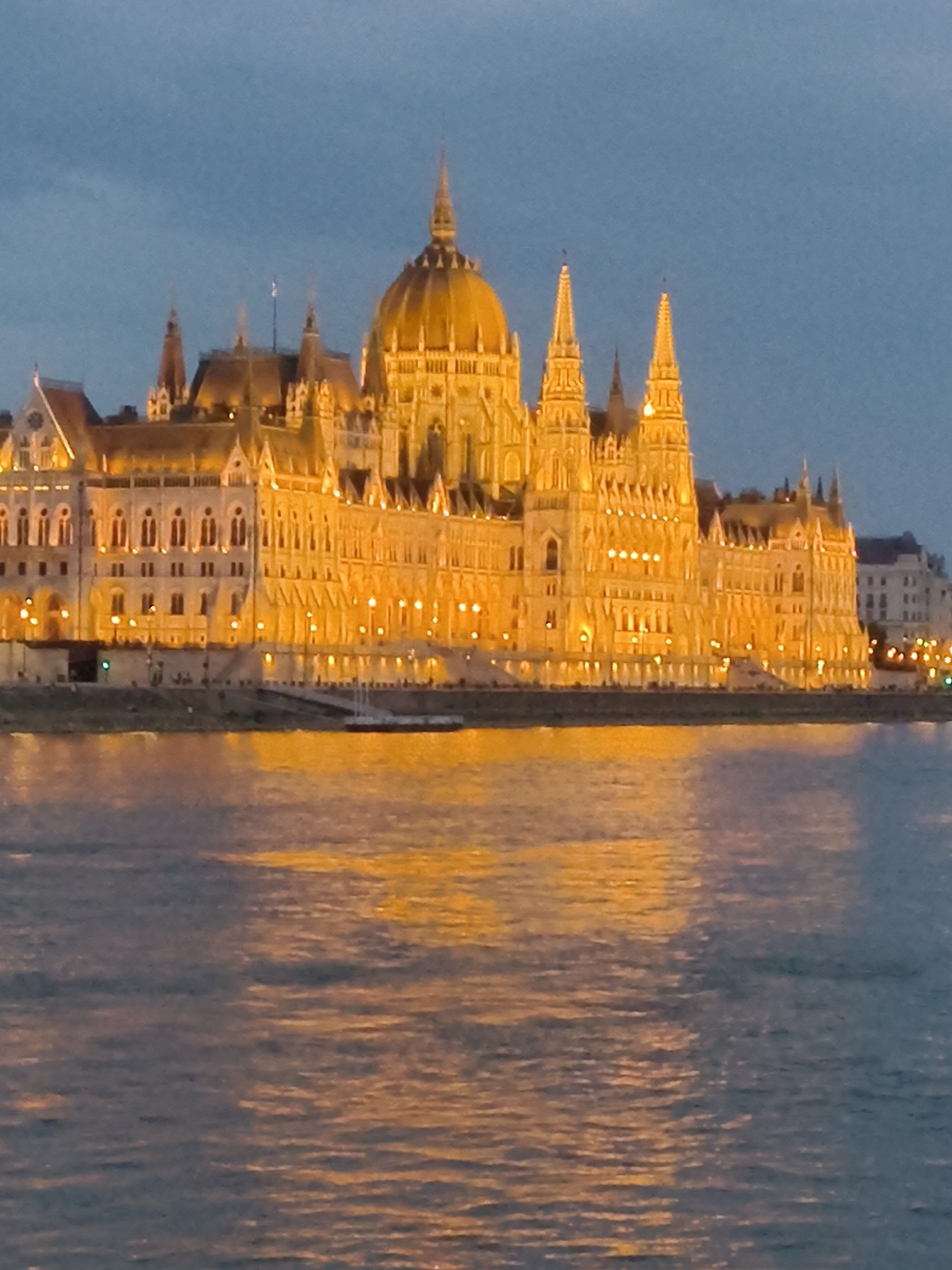 Hungarian Parliament Building glows golden at dusk in Budapest