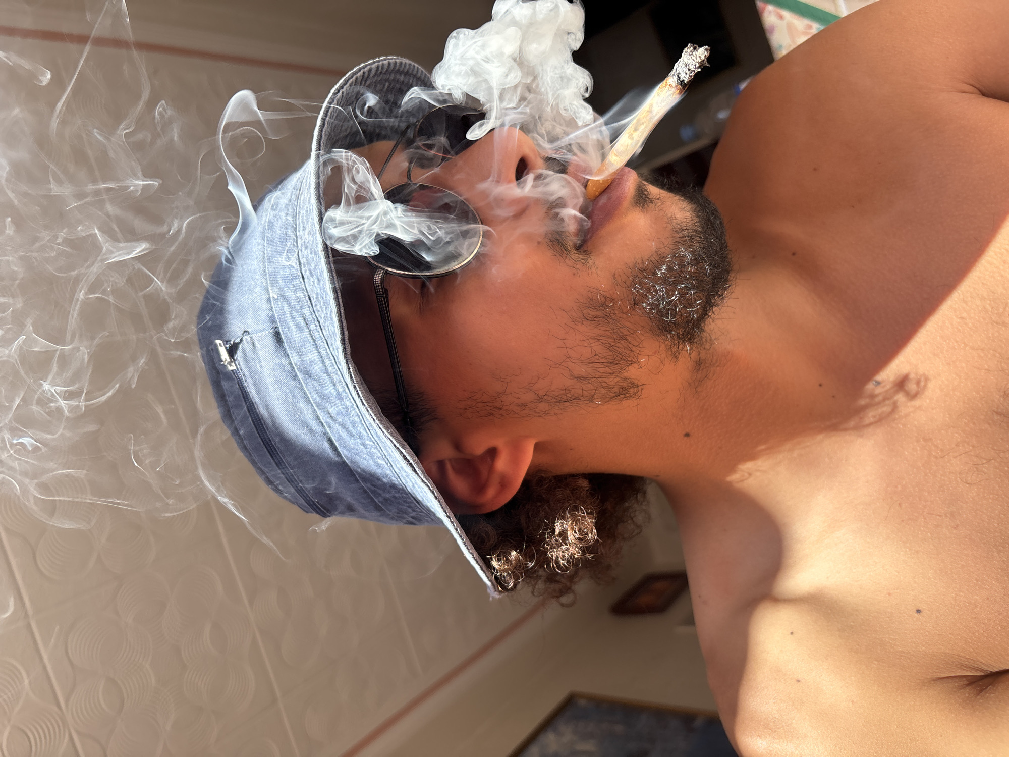 Man photographed smoking on Tangier terrace June afternoon