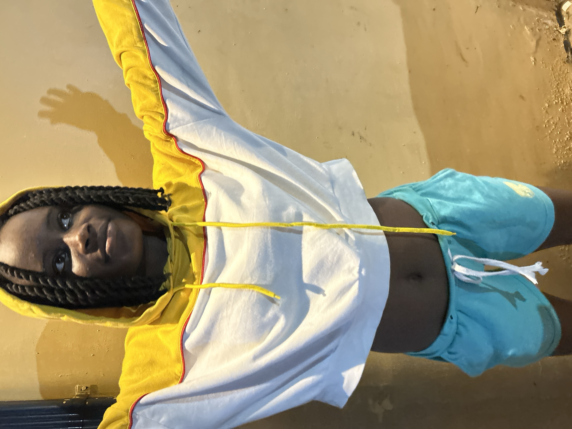 Youth in yellow hoodie captured in evening moments in Nigeria