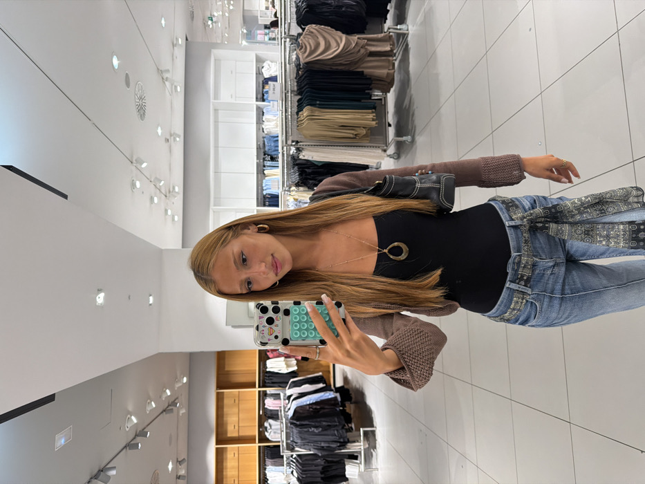 Young woman documents shopping trip across Alicante retail centers