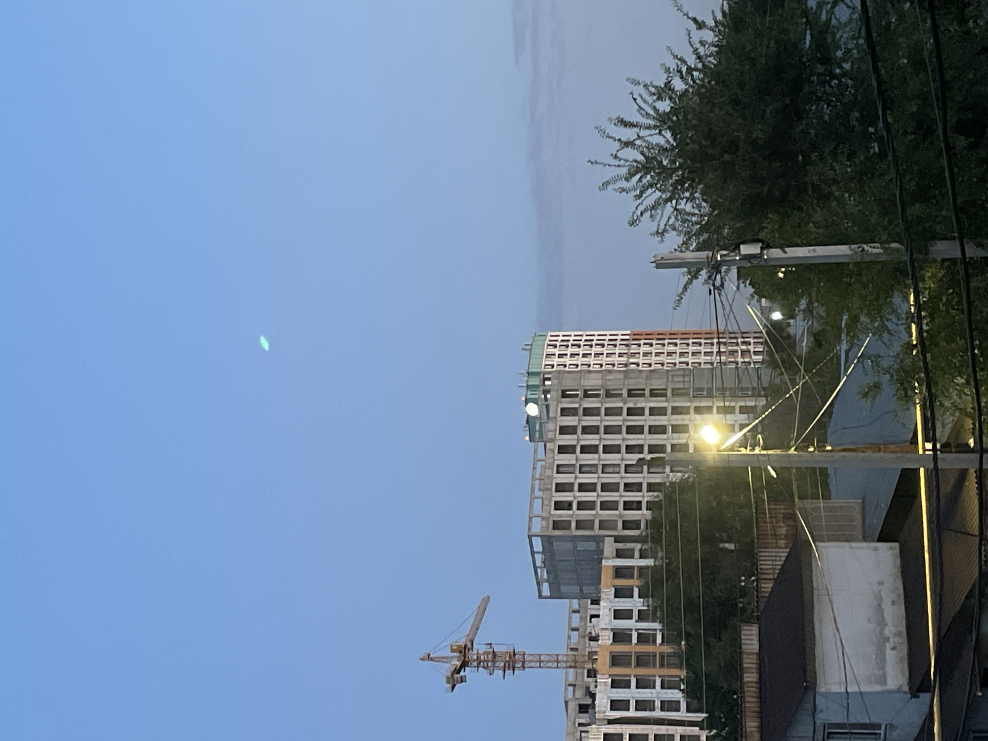 Almaty dusk: apartments, cranes, and quiet city edges