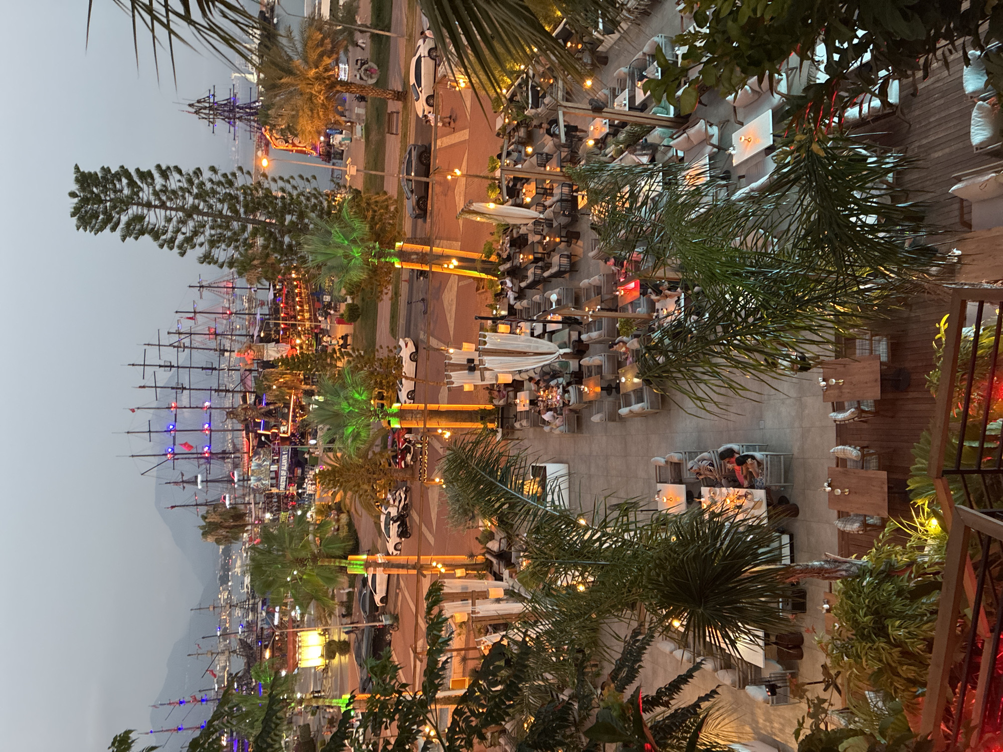Alanya harbor lights up at dusk with pirate ships and waterfront dining