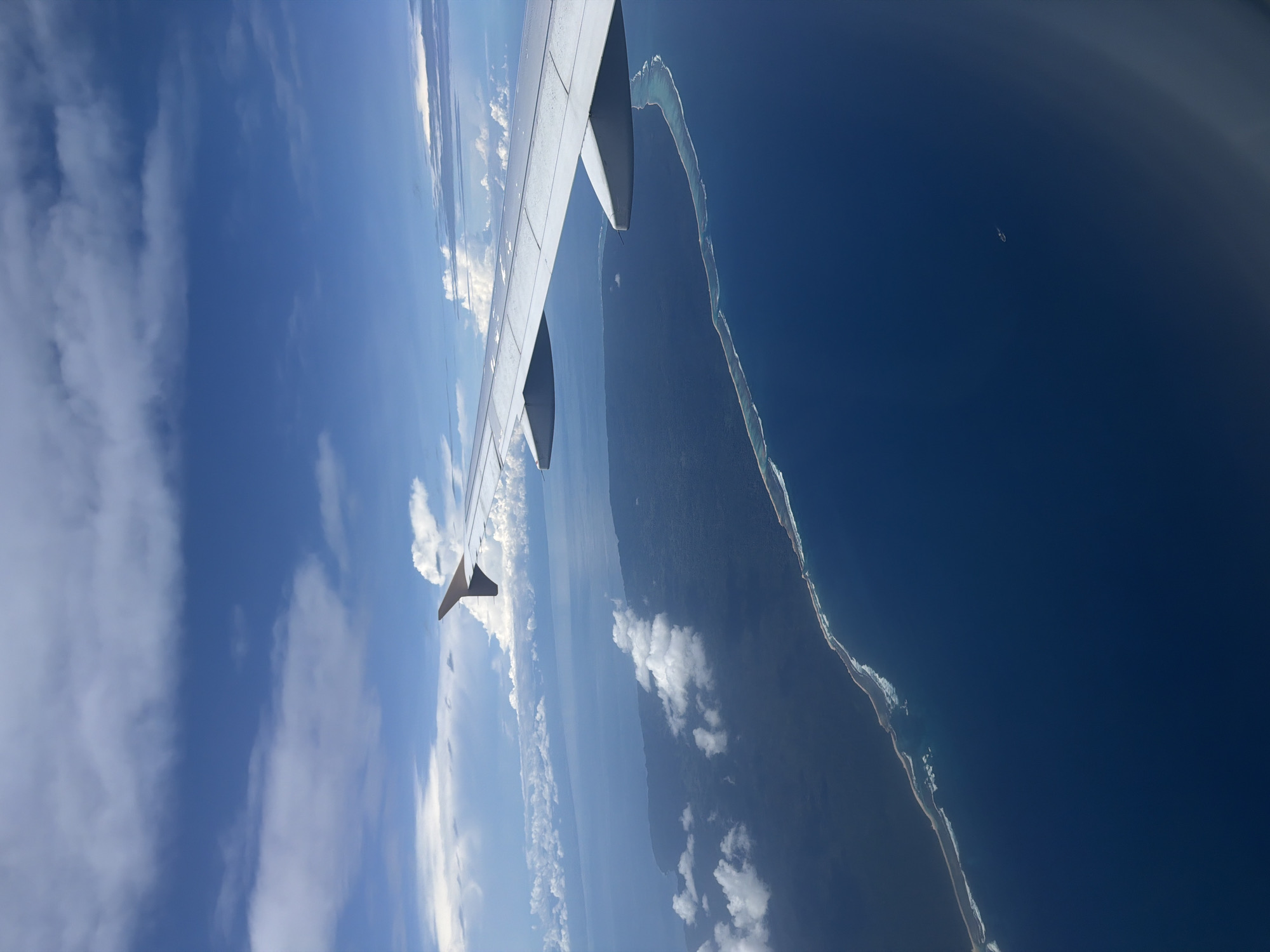 Passenger photographs aircraft wing over Indonesian waters during flight