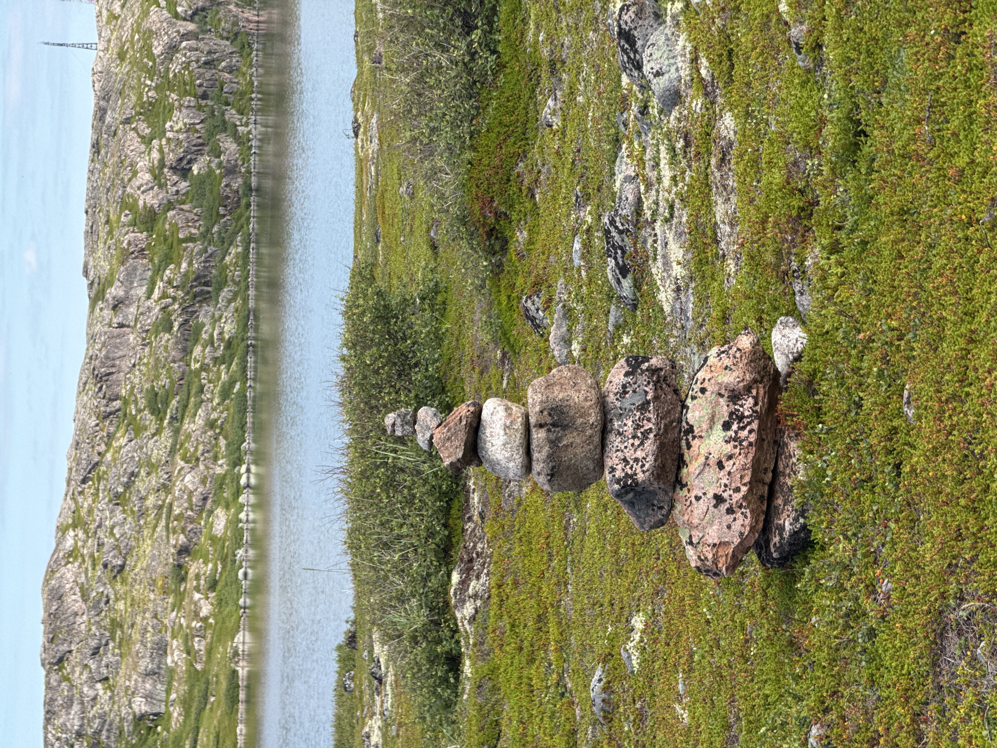 Exploring Teriberka's rocky boardwalk trail on a summer afternoon