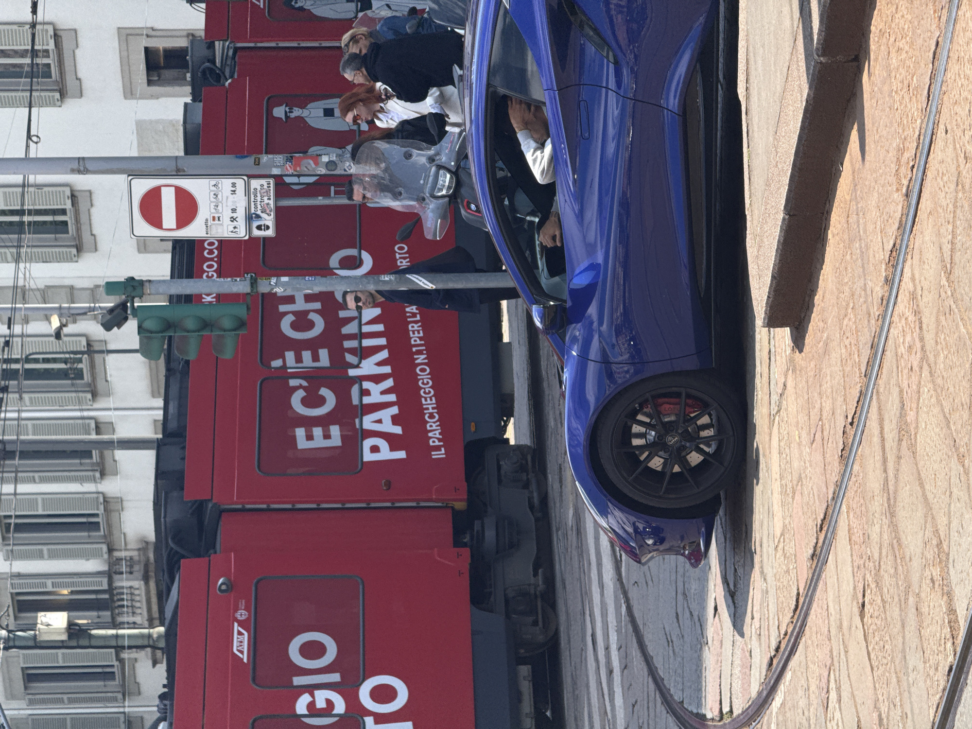 Milan street scene with parked vehicles and café accessories observed