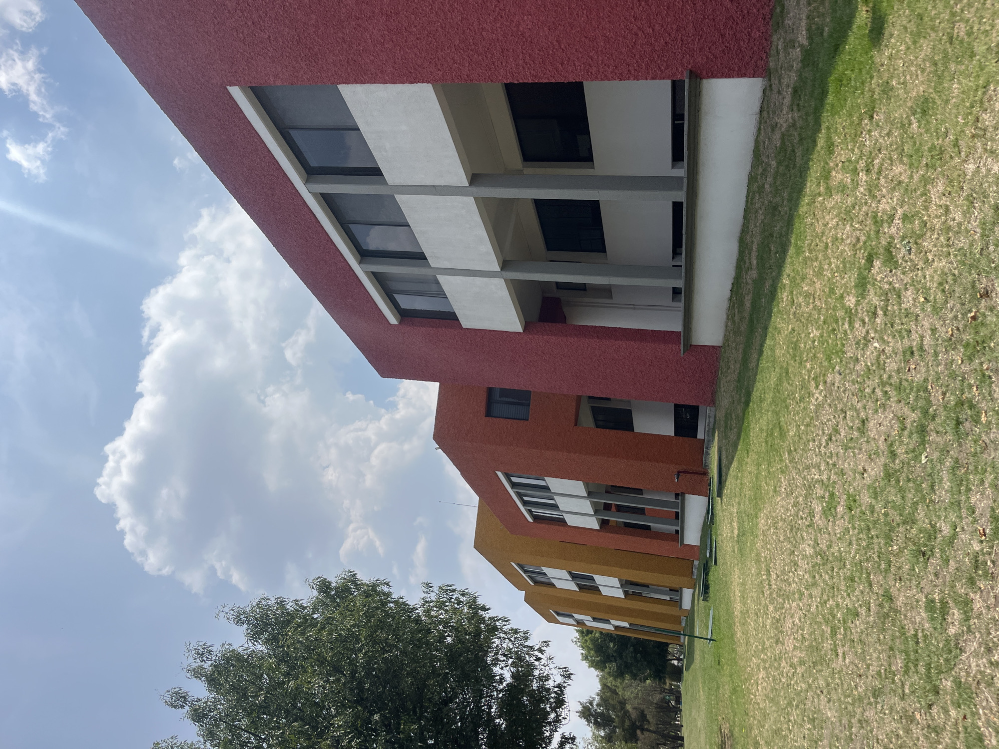 Gradient-painted buildings photographed in San Andrés Cholula, Mexico