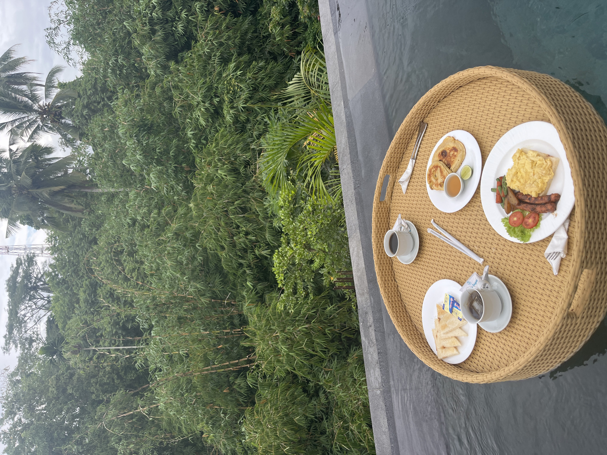 Floating breakfast served poolside in Tegallalang rainforest setting
