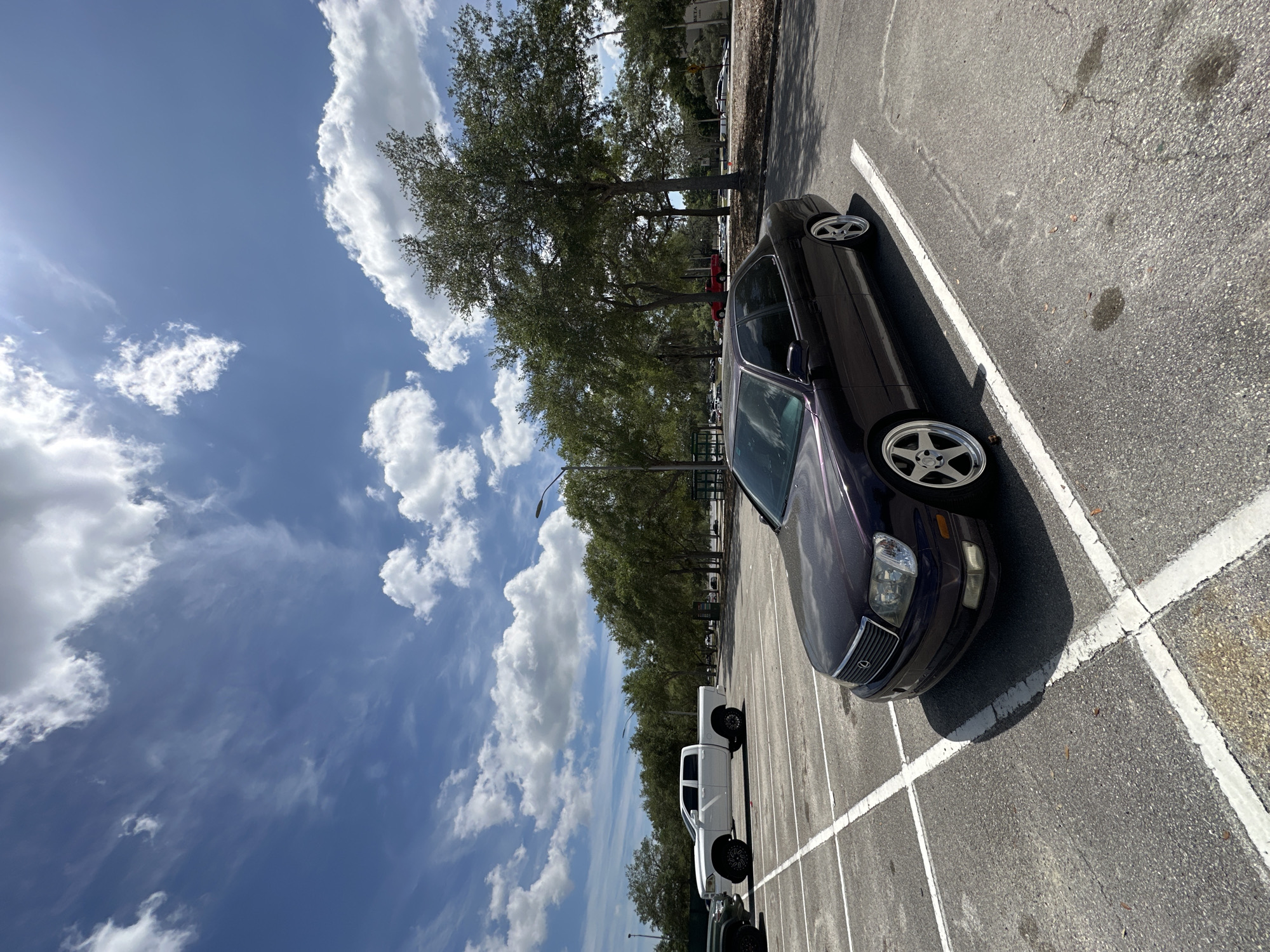 Purple sedan with custom wheels parked diagonally in Tampa lot