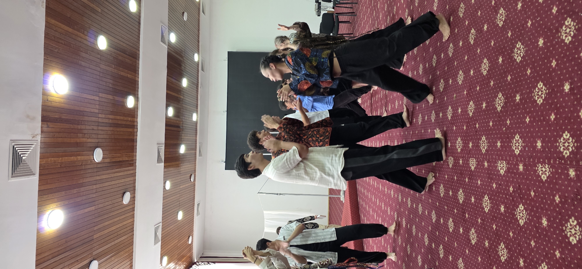 Performance rehearsal underway in a community hall, Bulan-Segettu