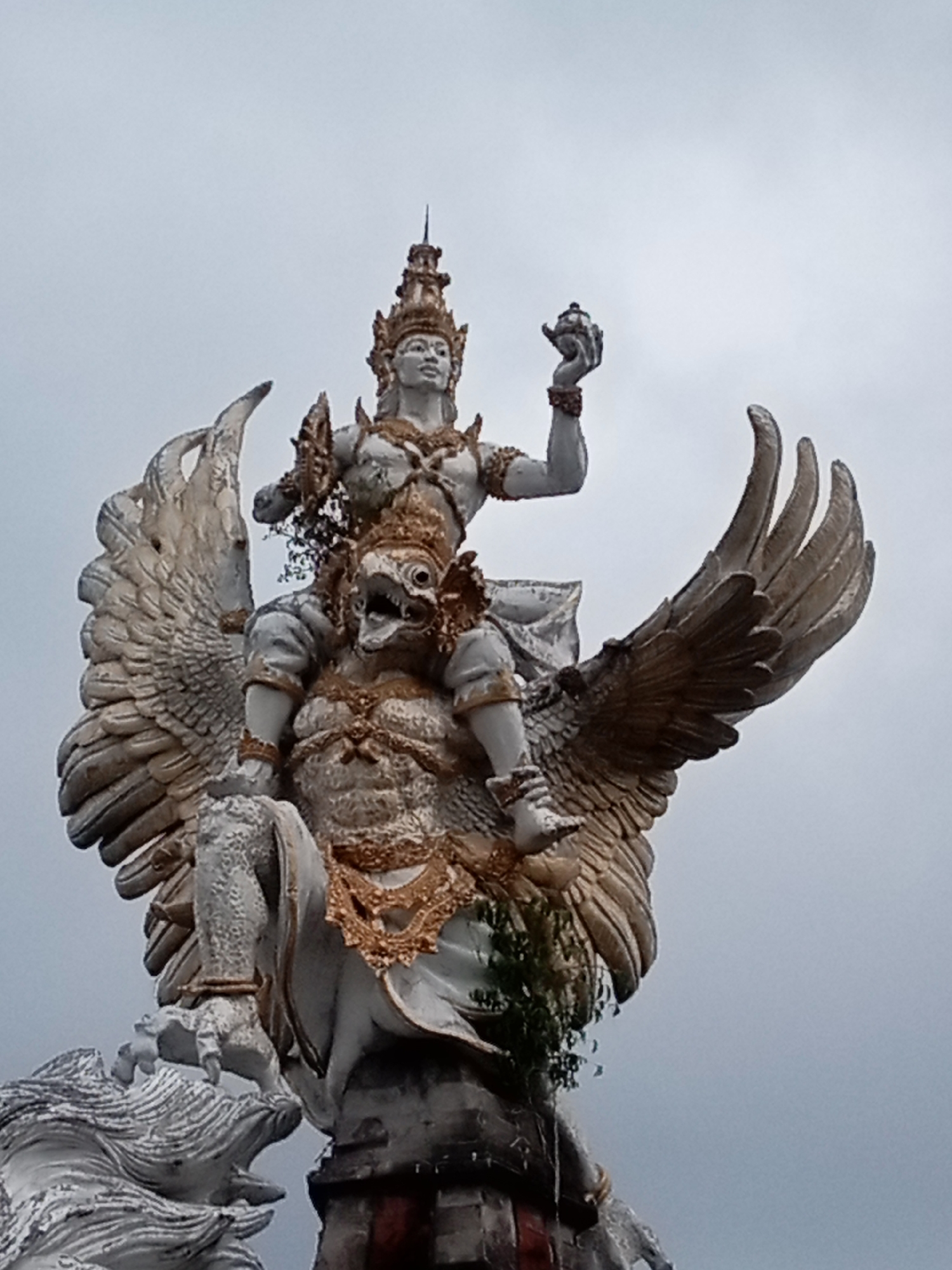 Ornate statues and mythical figures at a Southeast Asian monument complex