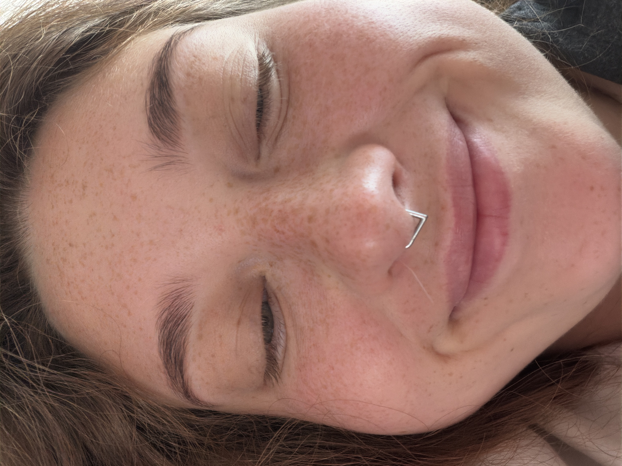 Close-up portrait with closed eyes and a quiet smile, Stryi