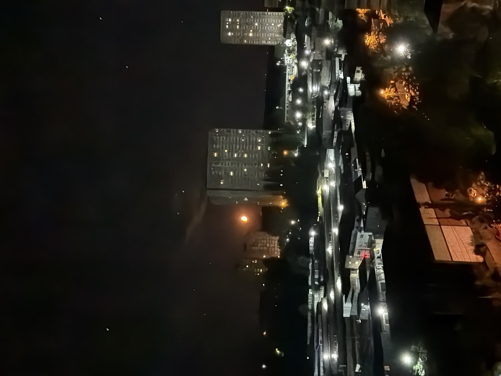 Kyiv at night: city lights under an orange moon