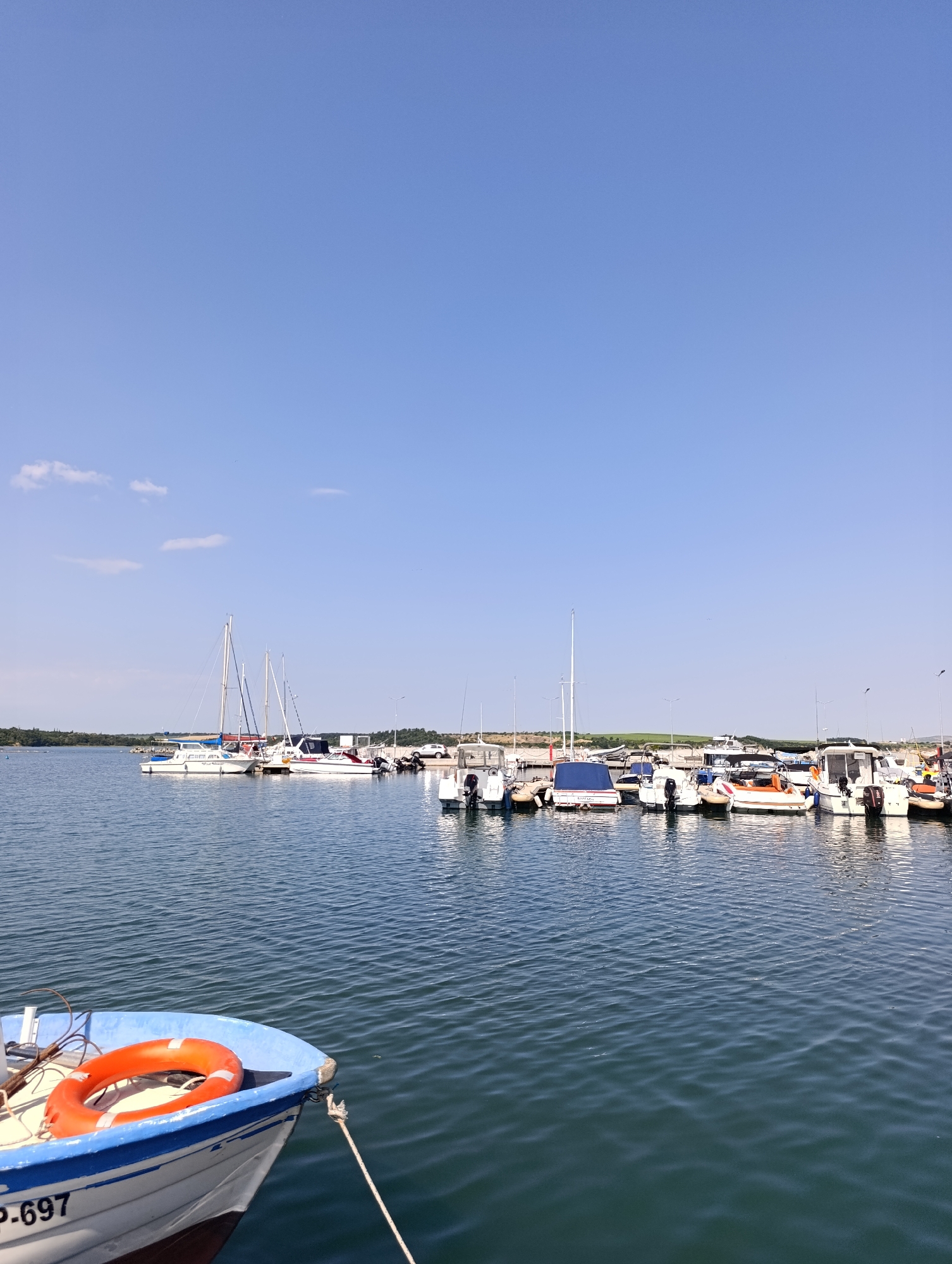 Burgas marina morning: boats, calm water, and an aquathlon event