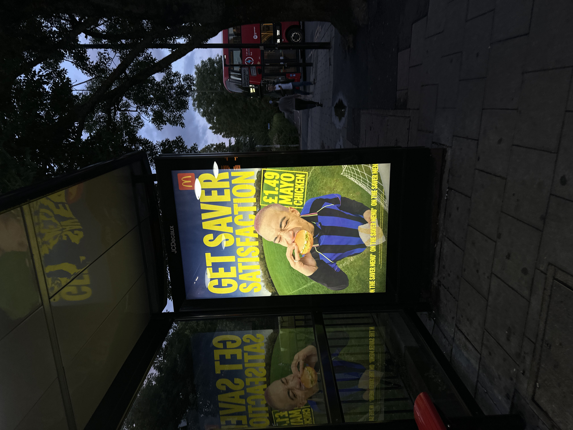McDonald's ad glows in London bus shelter at dusk