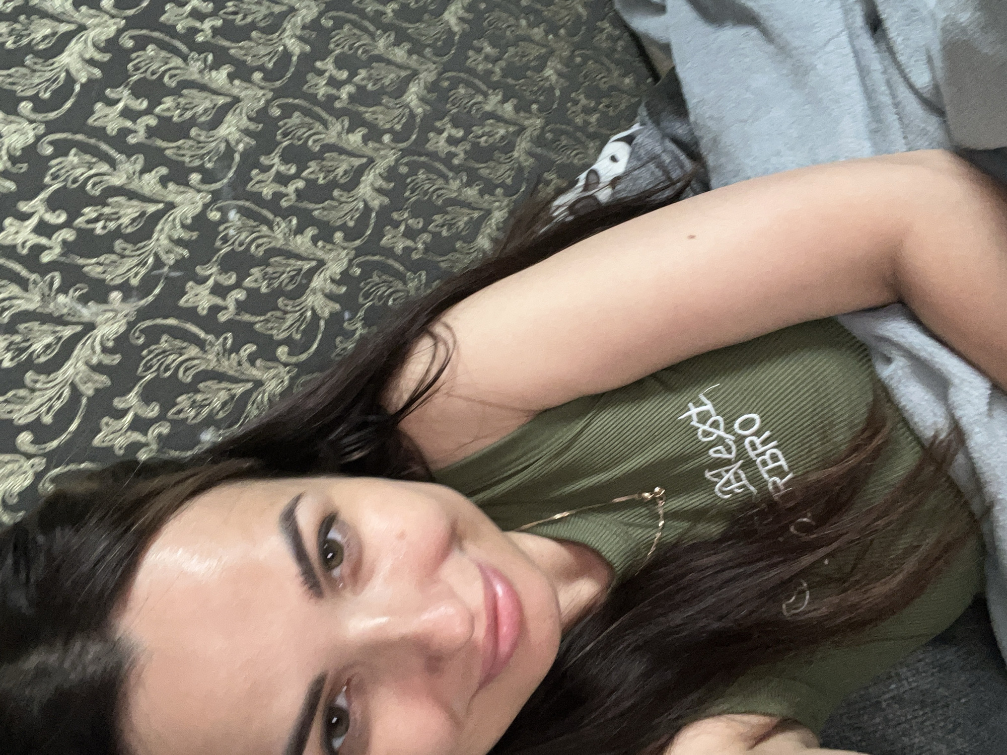 Lazy morning in bed, green tank top, sleepy dog included