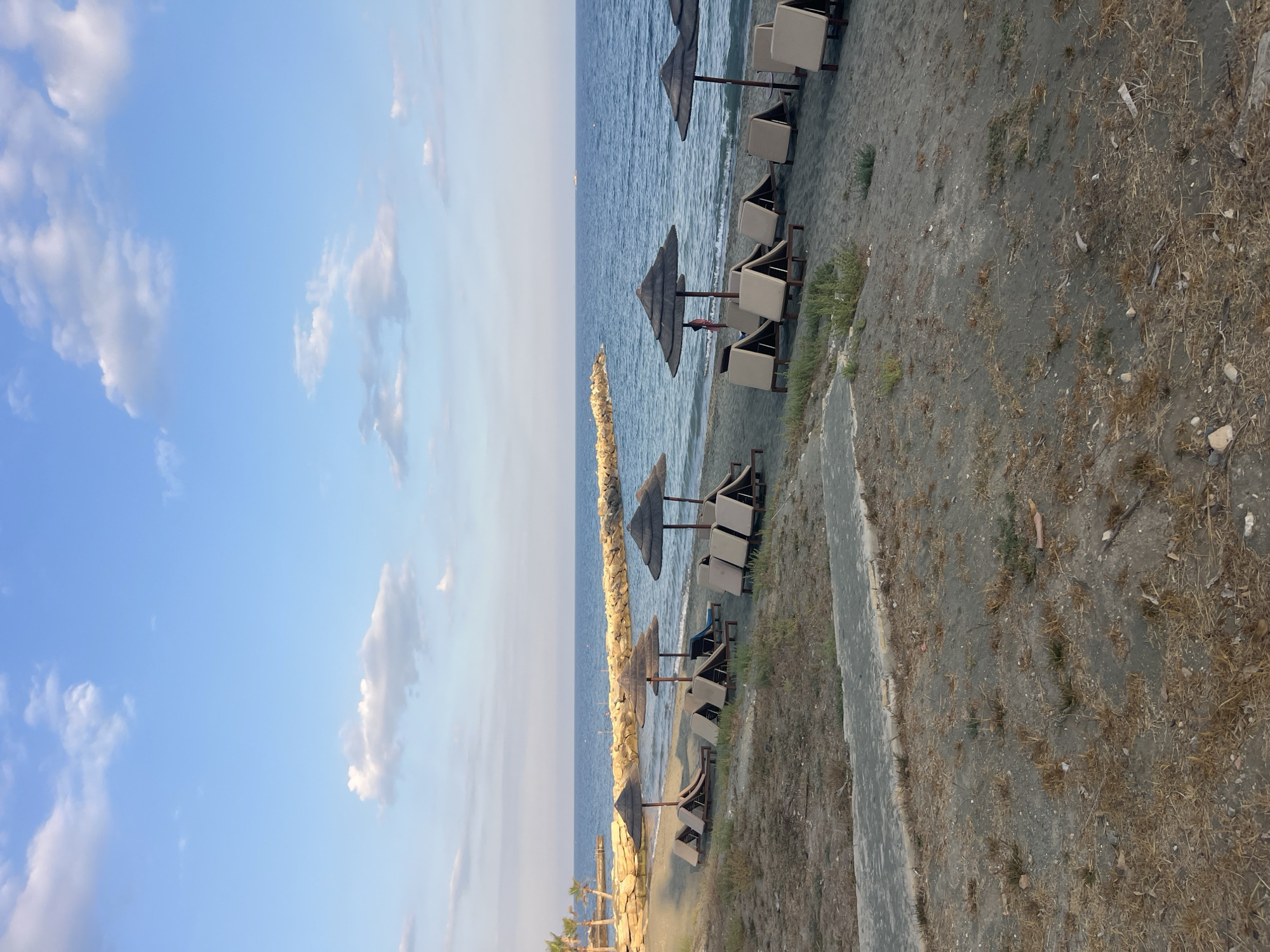 Cyprus coastal promenade with beach, gardens, and offshore water park